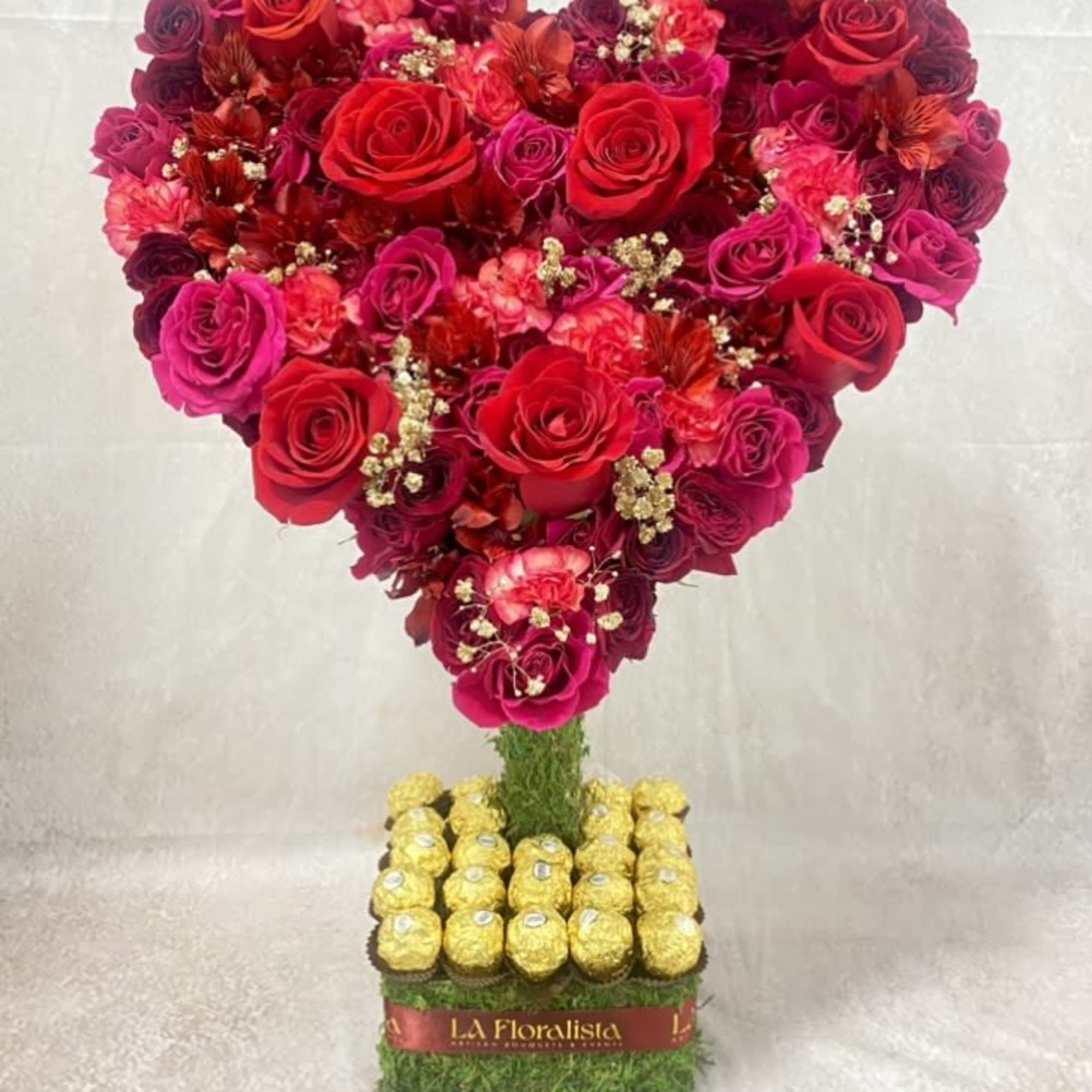 Heart-shaped rose arrangement with Ferrero Rocher chocolates on a square base