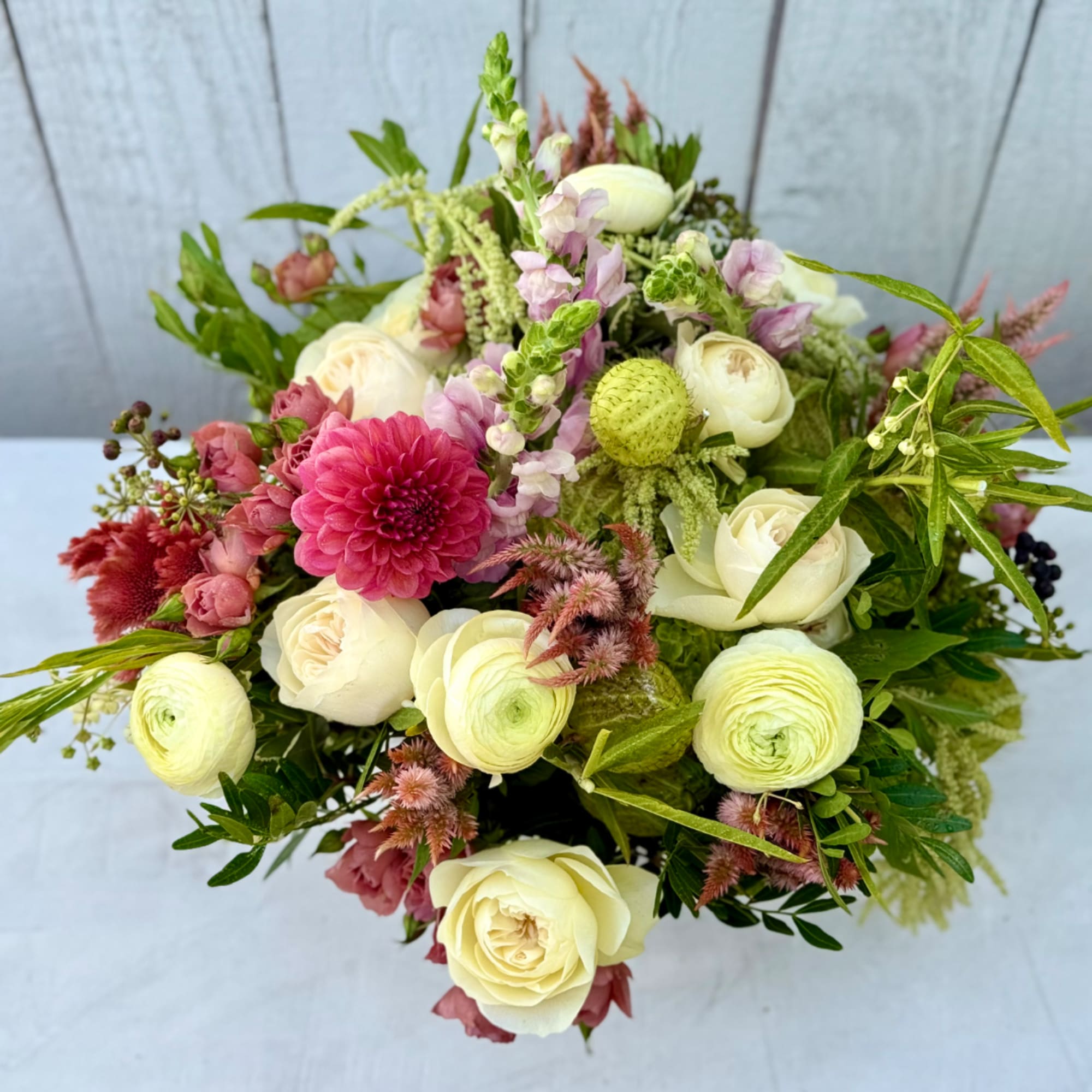 Mixed bouquet of cream, pink, and green flowers