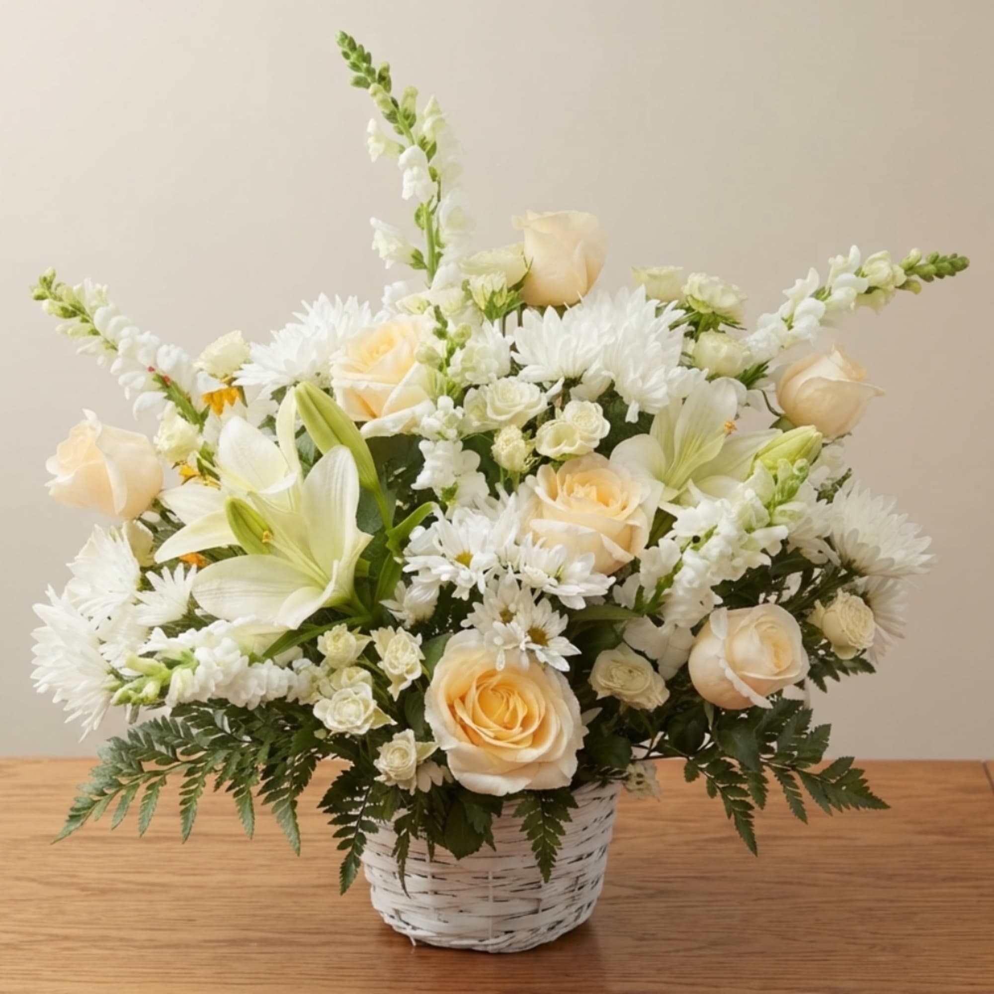 Cream roses and white lilies in a white basket vase