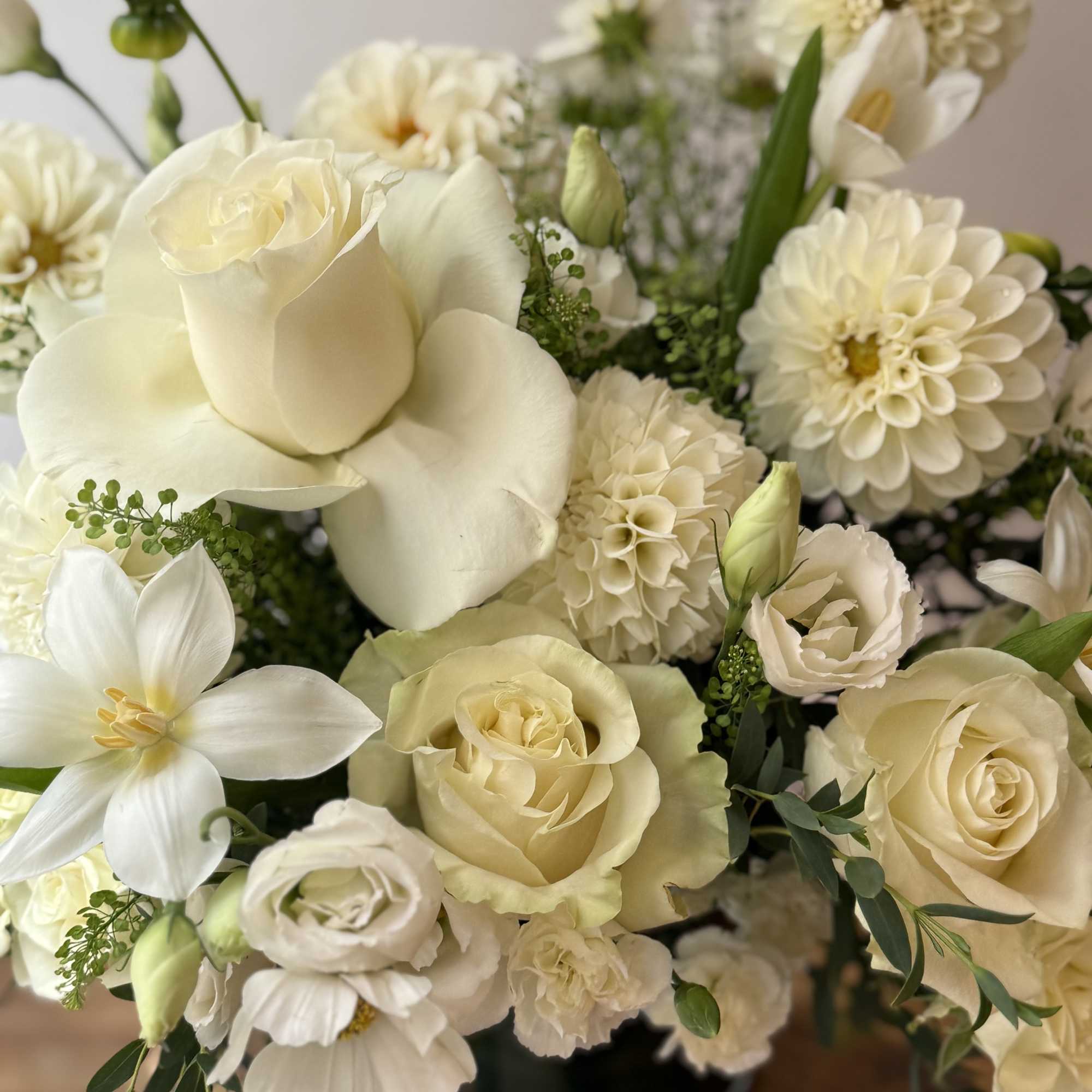 Creamy white bouquet with roses, dahlias, and lilies in a vase