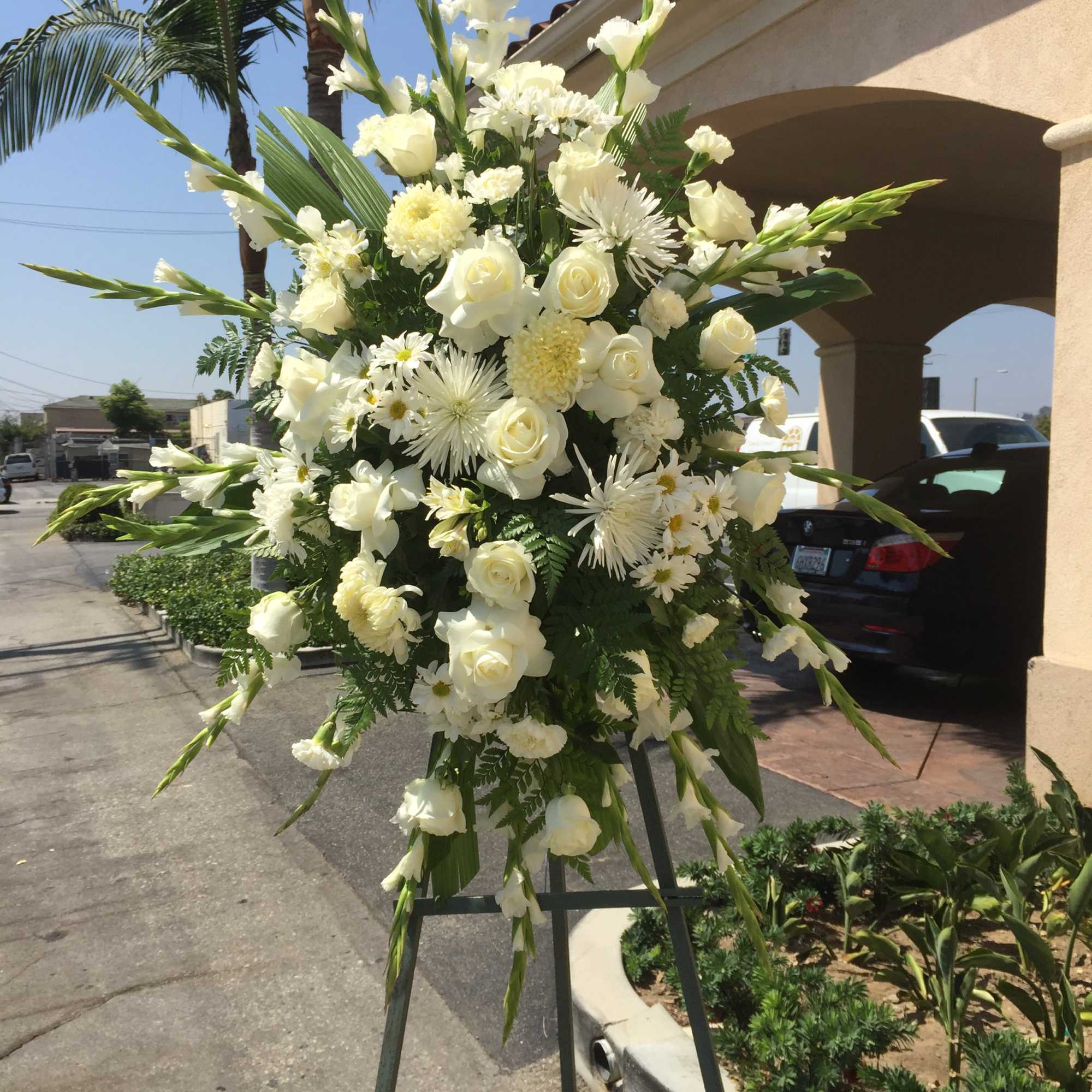 Large white floral standing spray on an easel