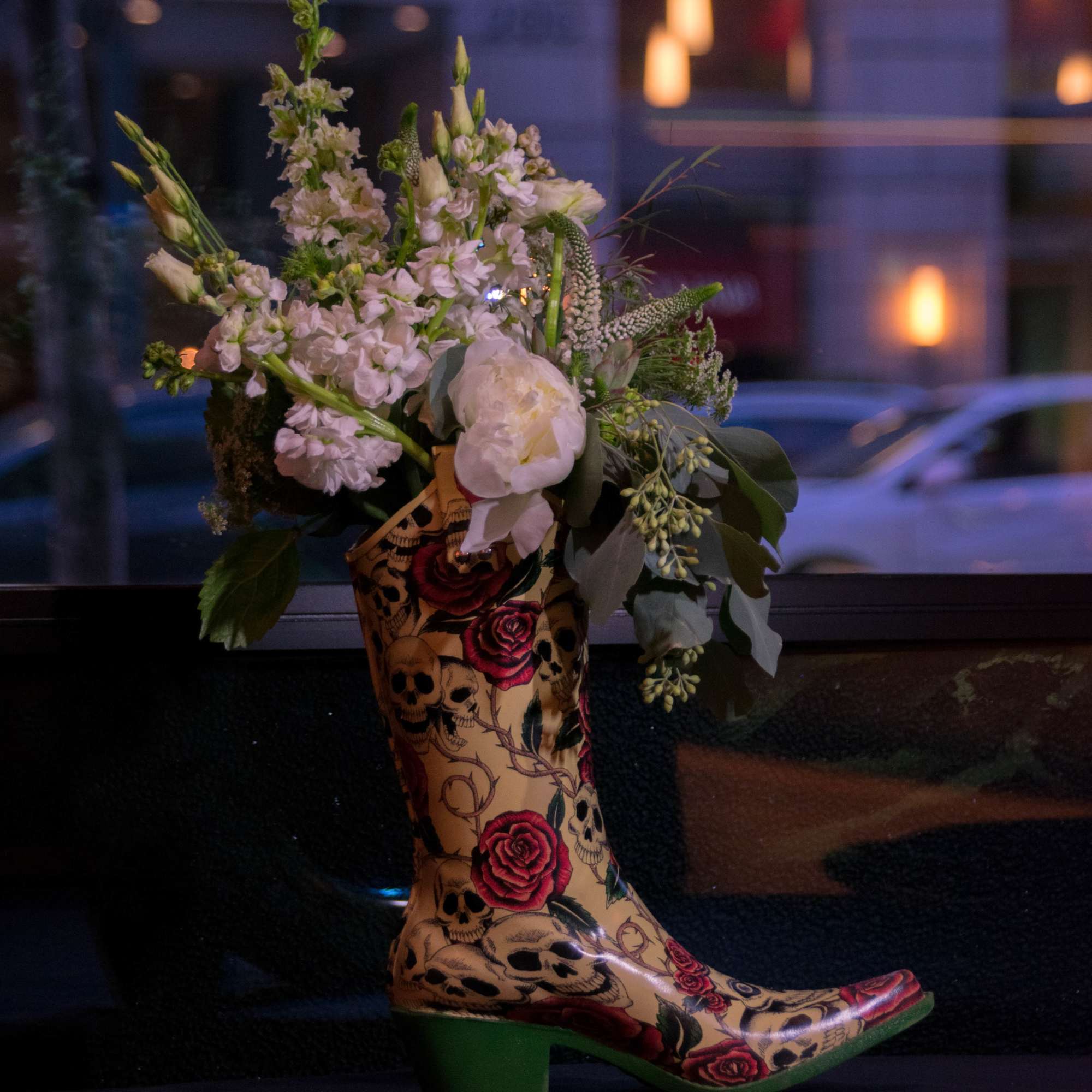 Floral arrangement in a decorative cowboy boot vase