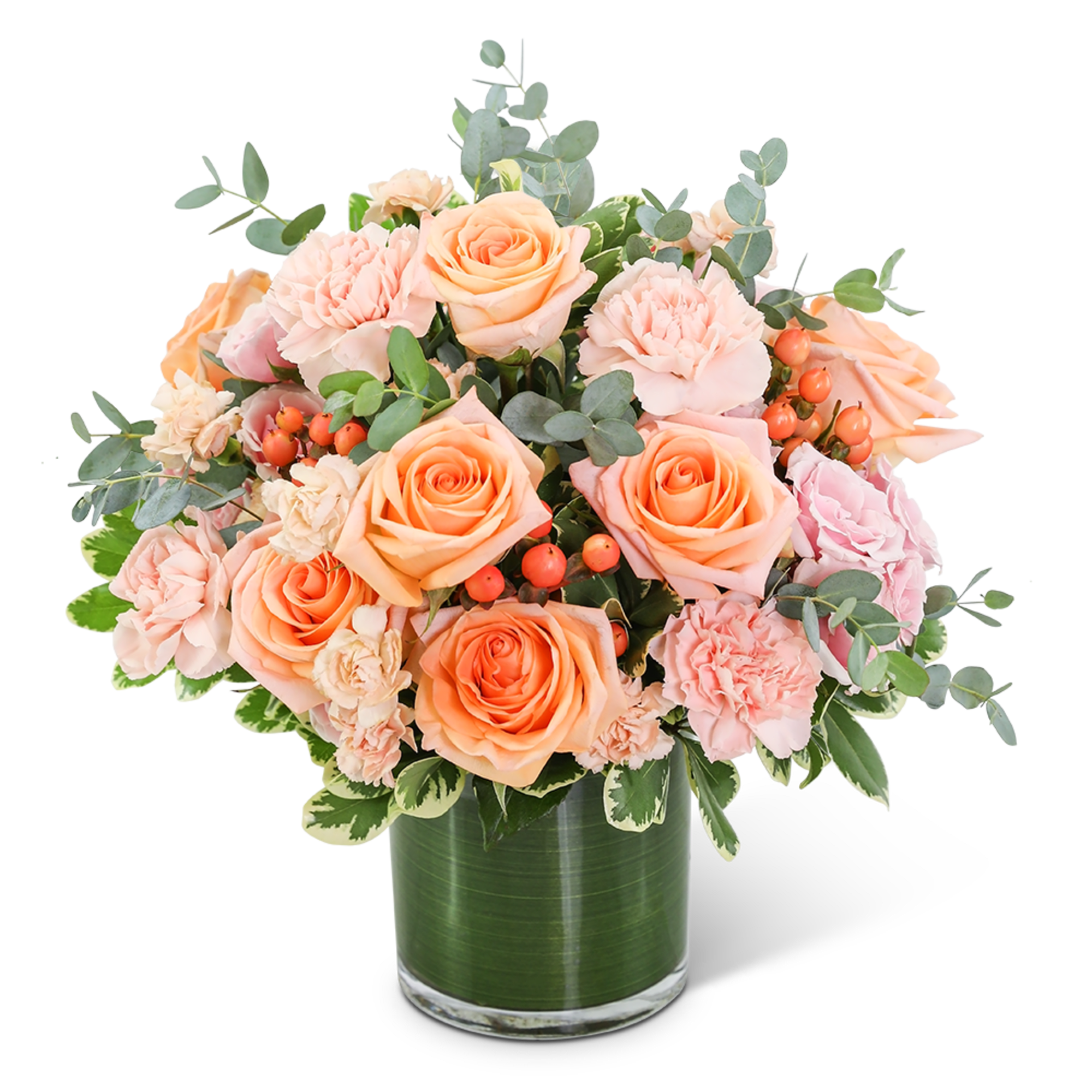 Peach roses and pink carnations in a glass vase
