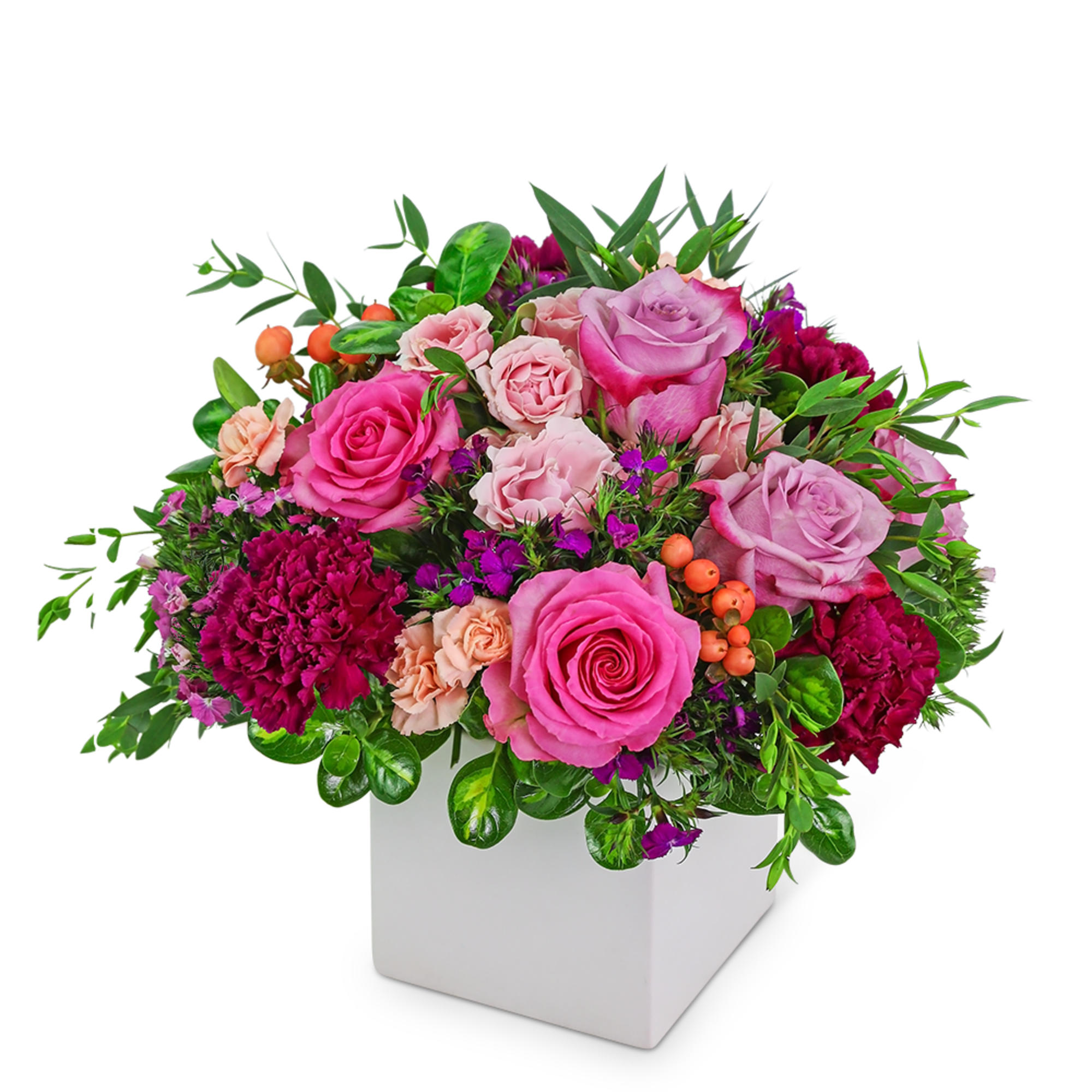Pink and lavender roses with carnations in a white square vase