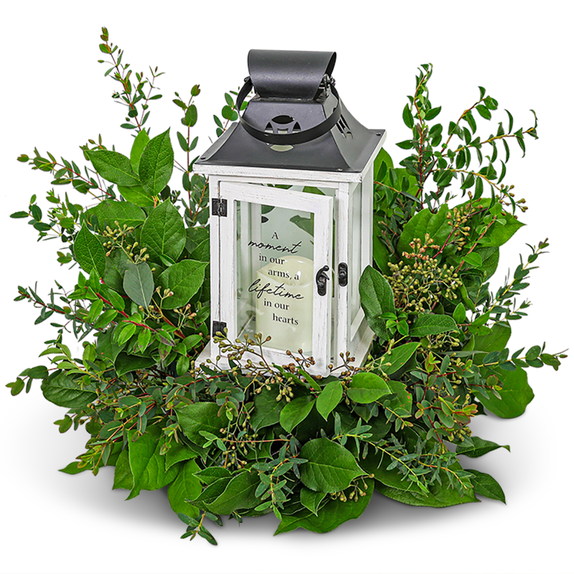 White lantern centerpiece surrounded by green foliage