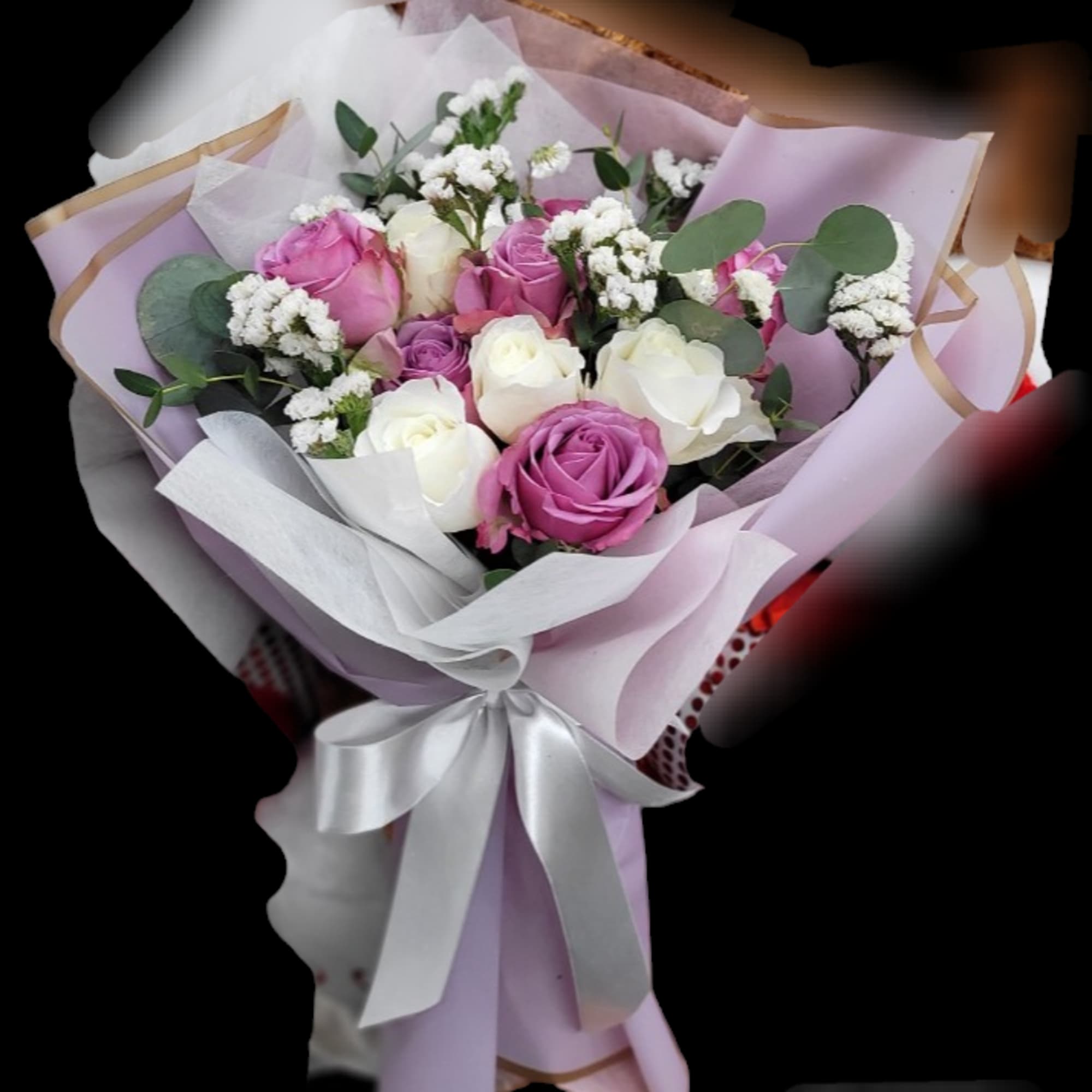 Bouquet of pink, purple, and white roses with baby's breath