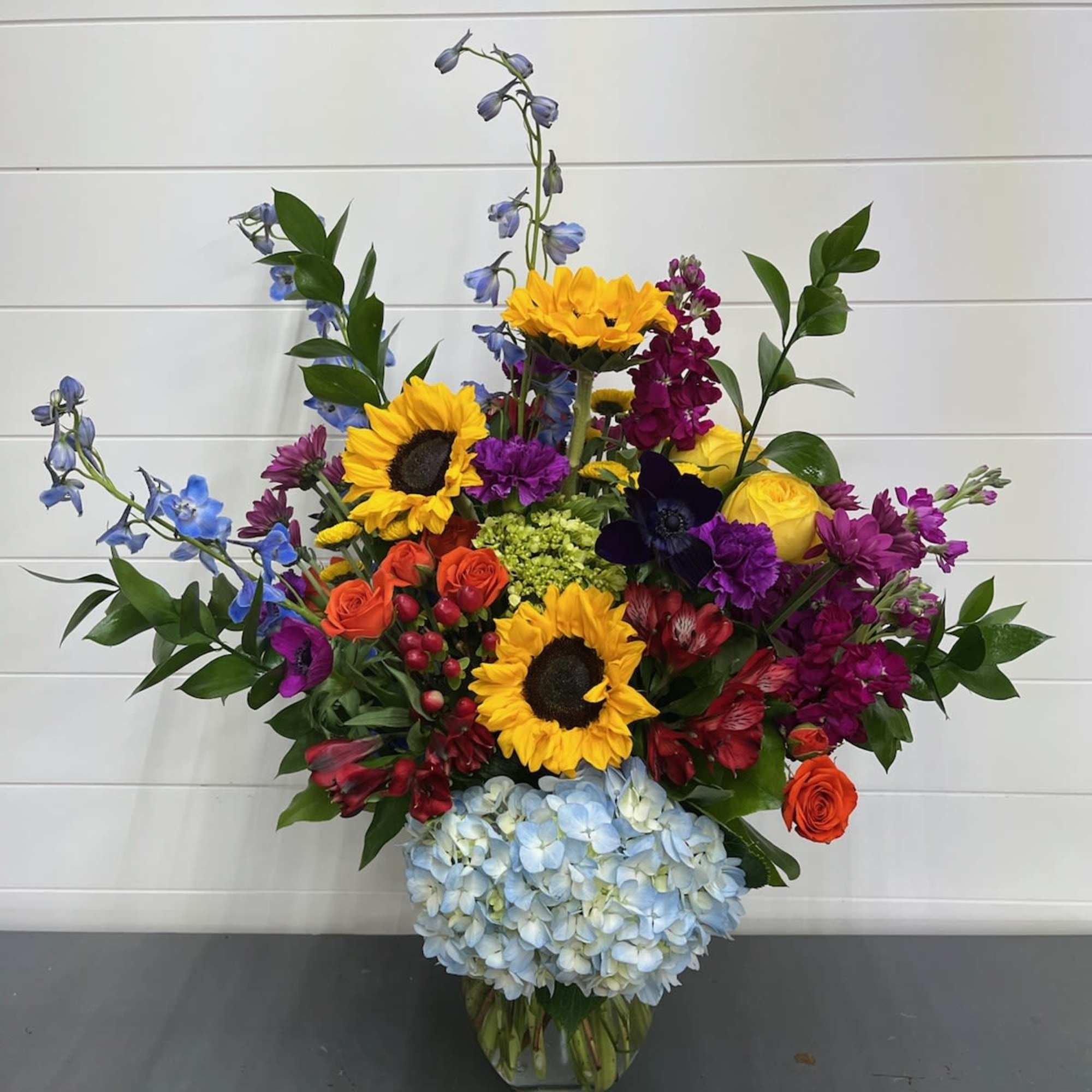 Colorful mixed flower arrangement in a clear glass vase