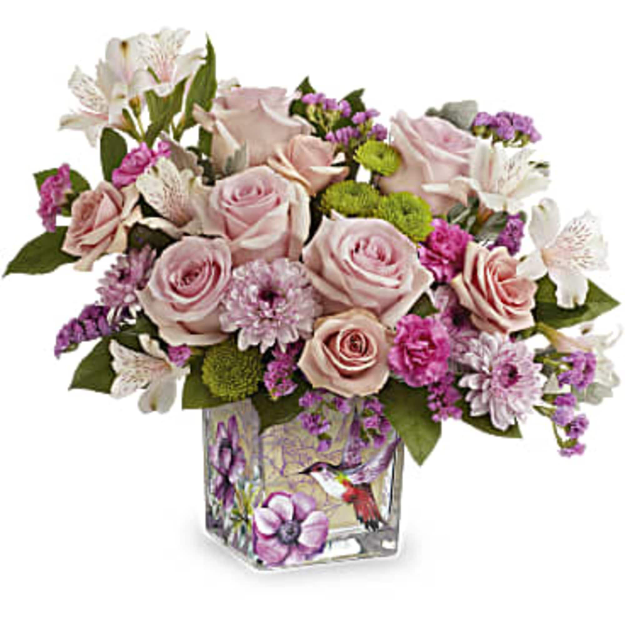 Pink roses and mixed blooms in a square glass vase