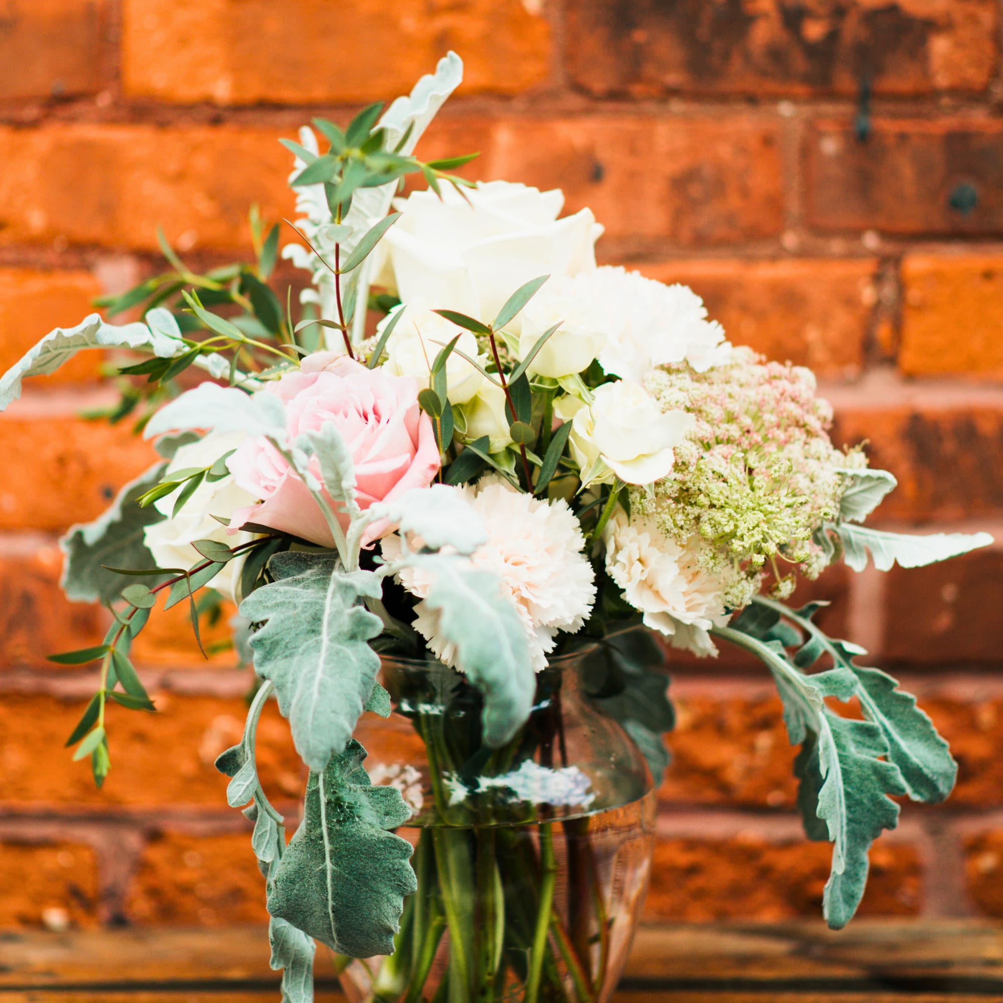 Pink and white bouquet in a clear glass vase