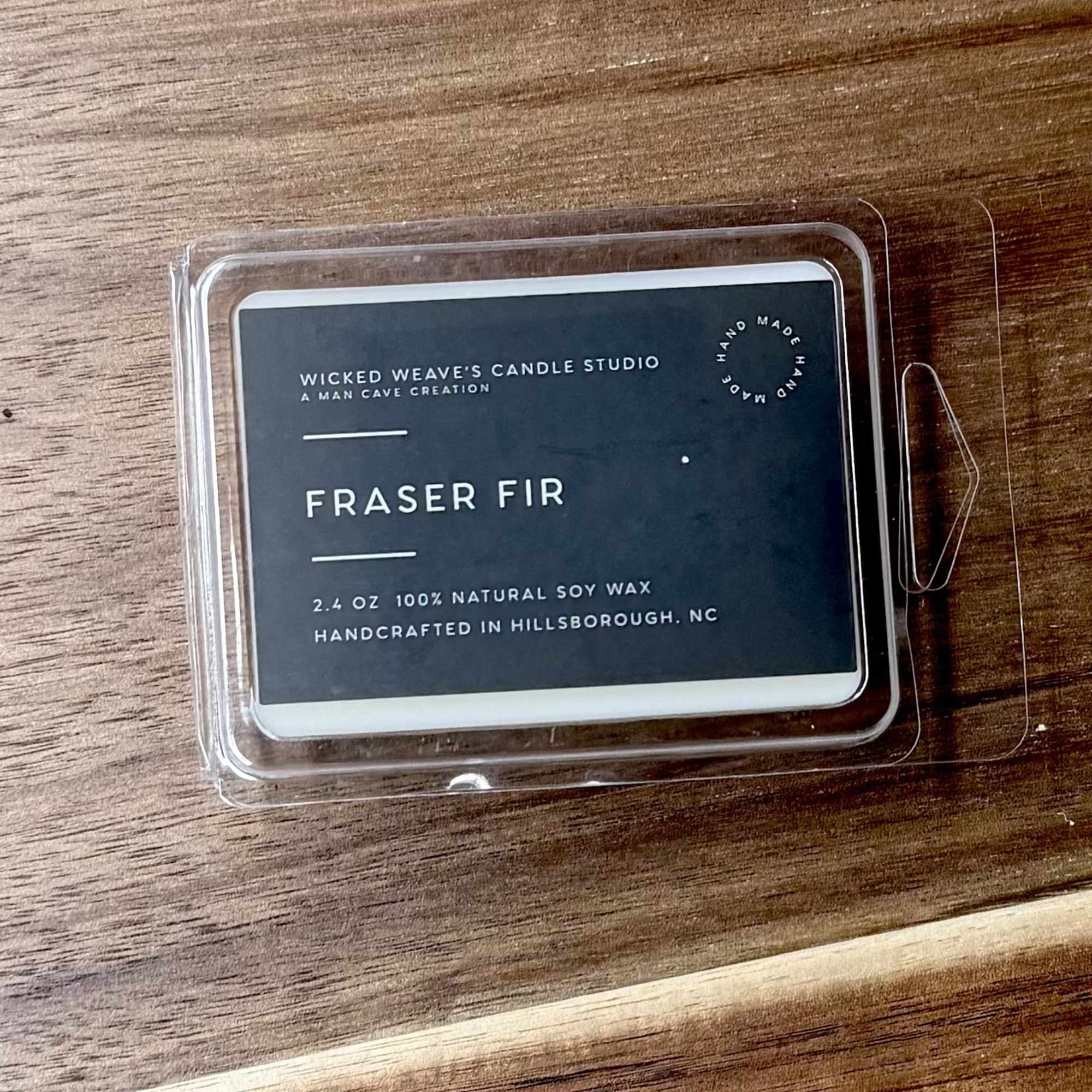 Fraser Fir soy wax candle in a clear plastic clamshell