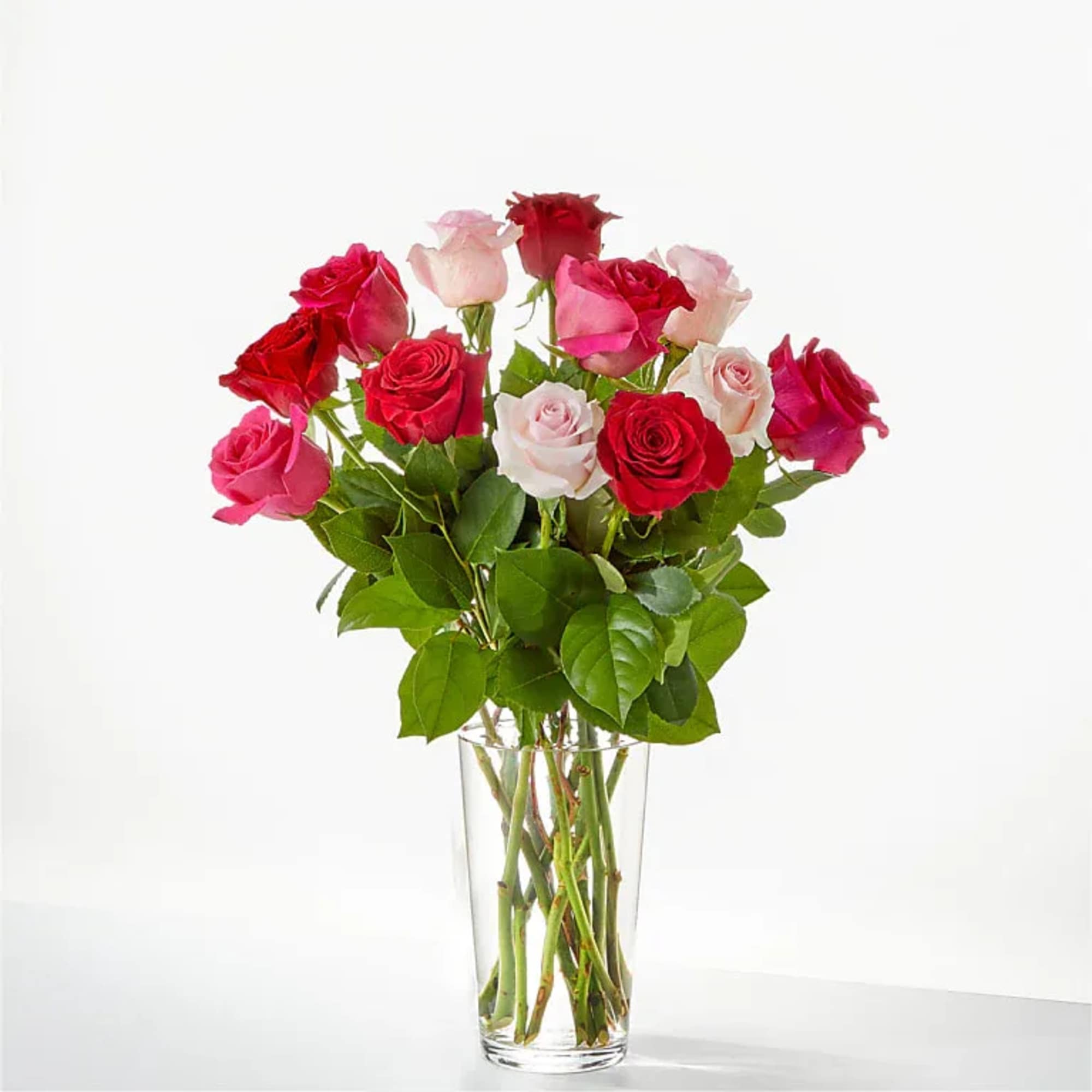 Bouquet of red and pink roses in a clear glass vase