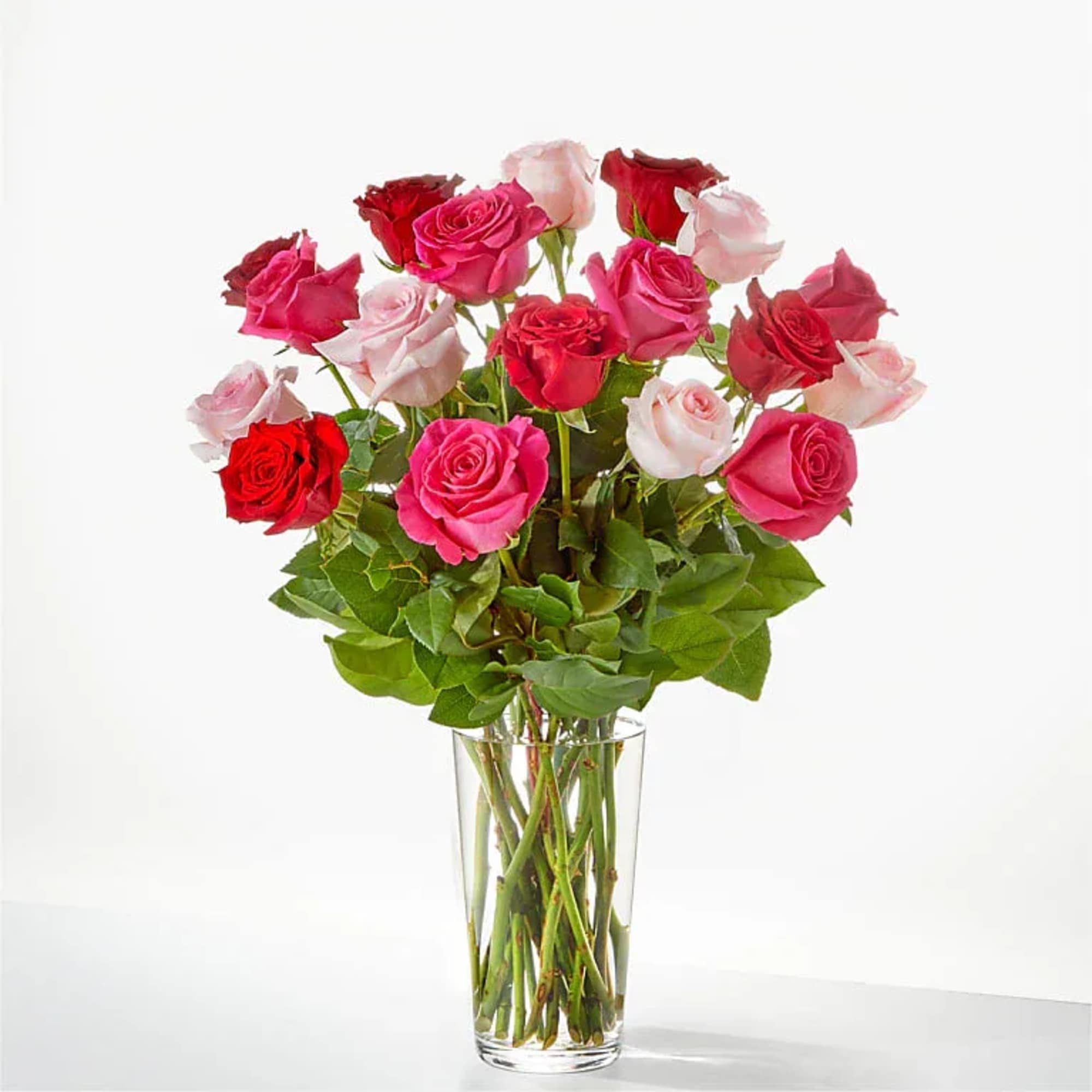Bouquet of pink and red roses in a clear glass vase