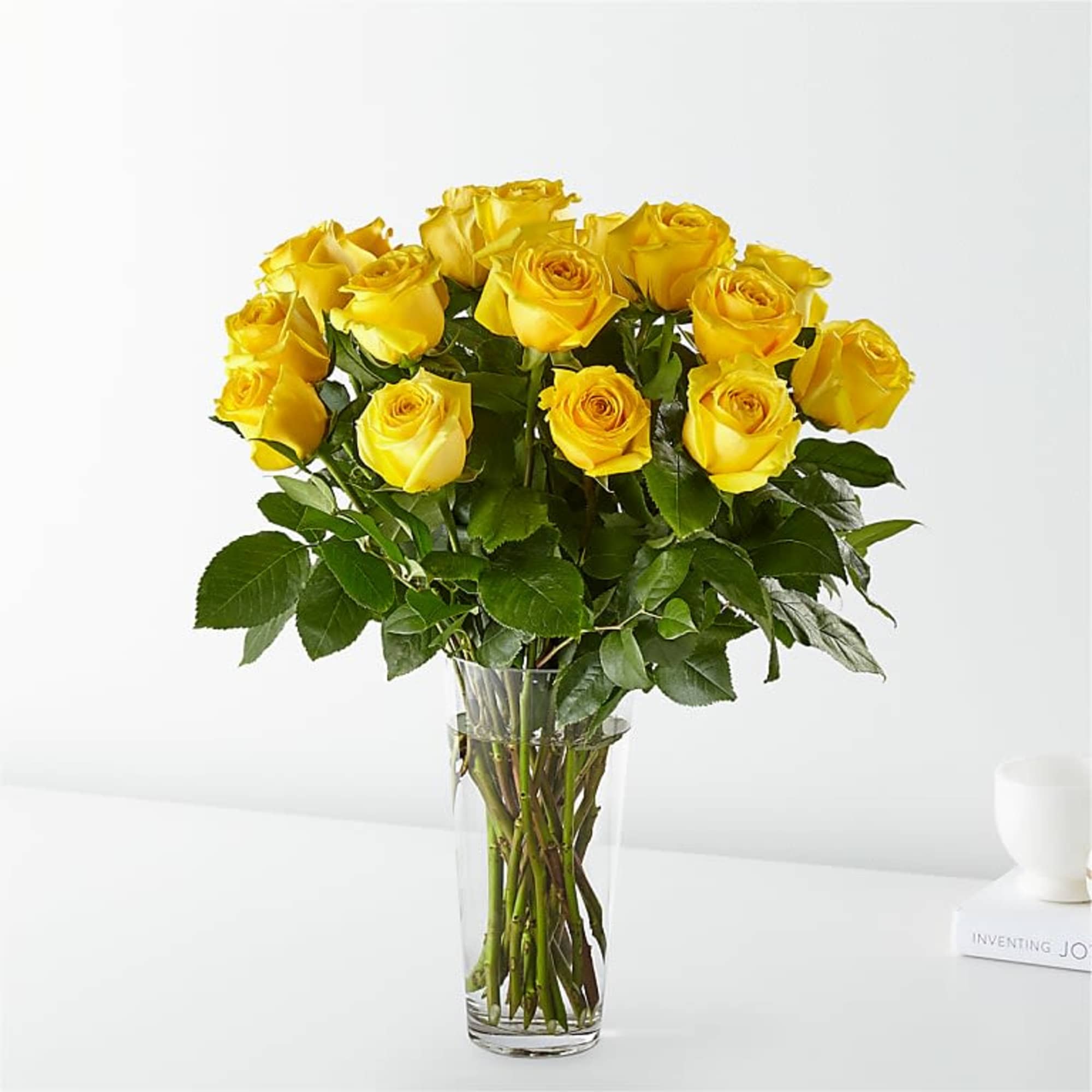 Bouquet of yellow roses in a clear glass vase, photo 2 of 3