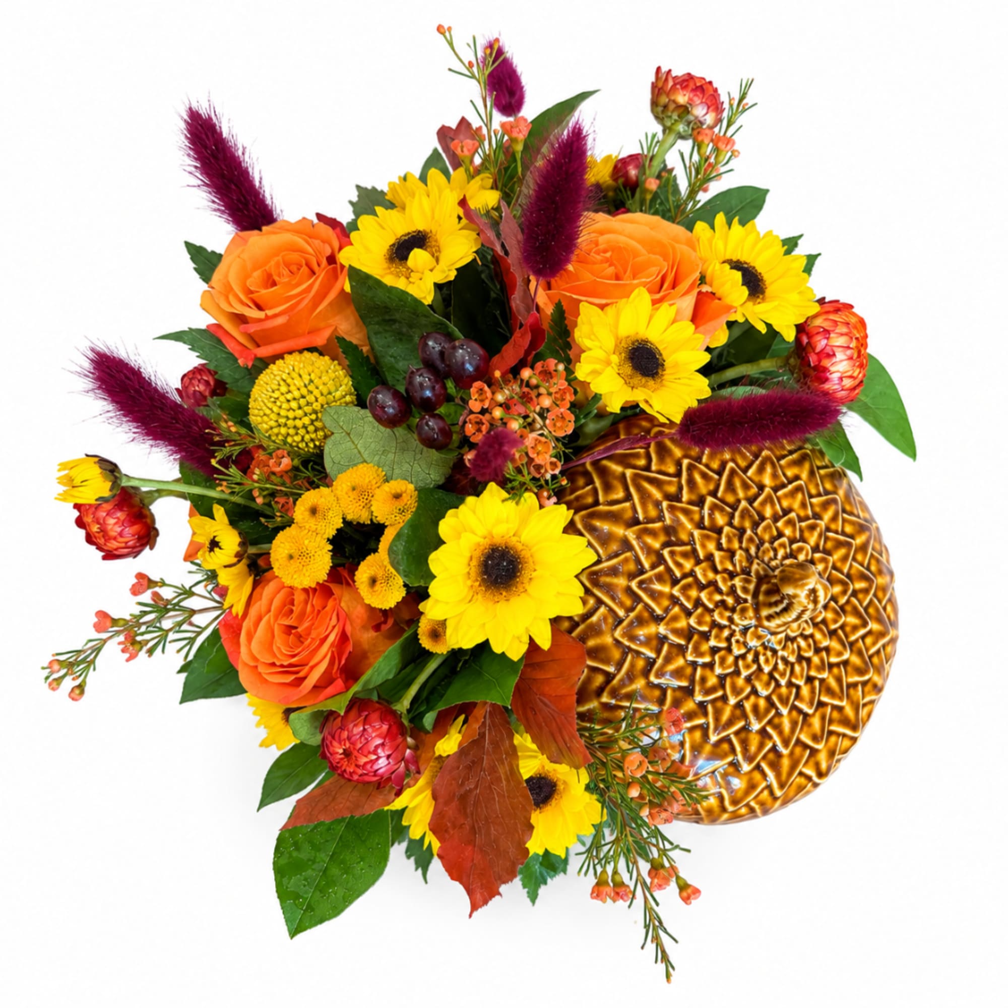 Orange roses and yellow sunflowers arranged in a gold vase