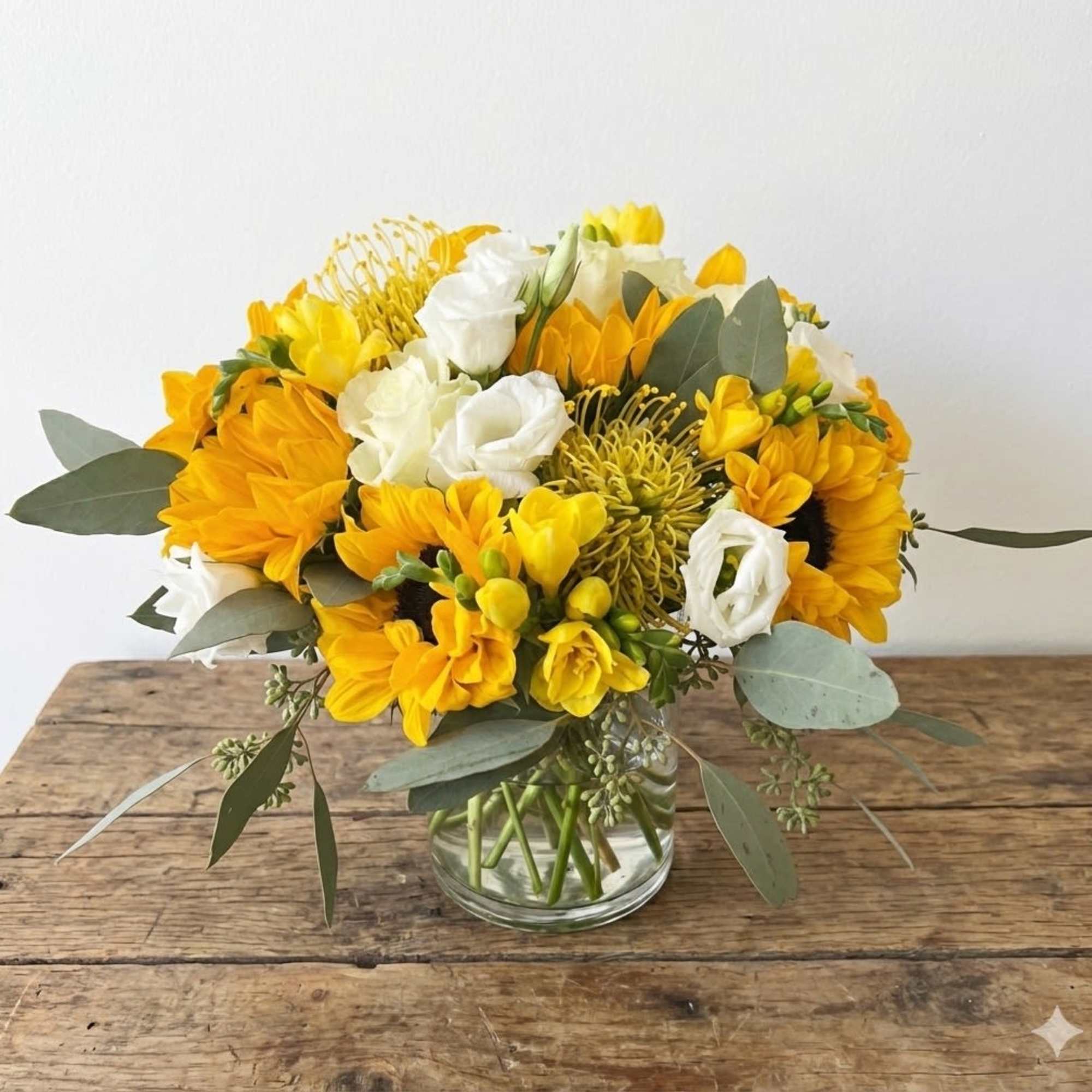 A yellow and white floral arrangement in a vase, designed to add