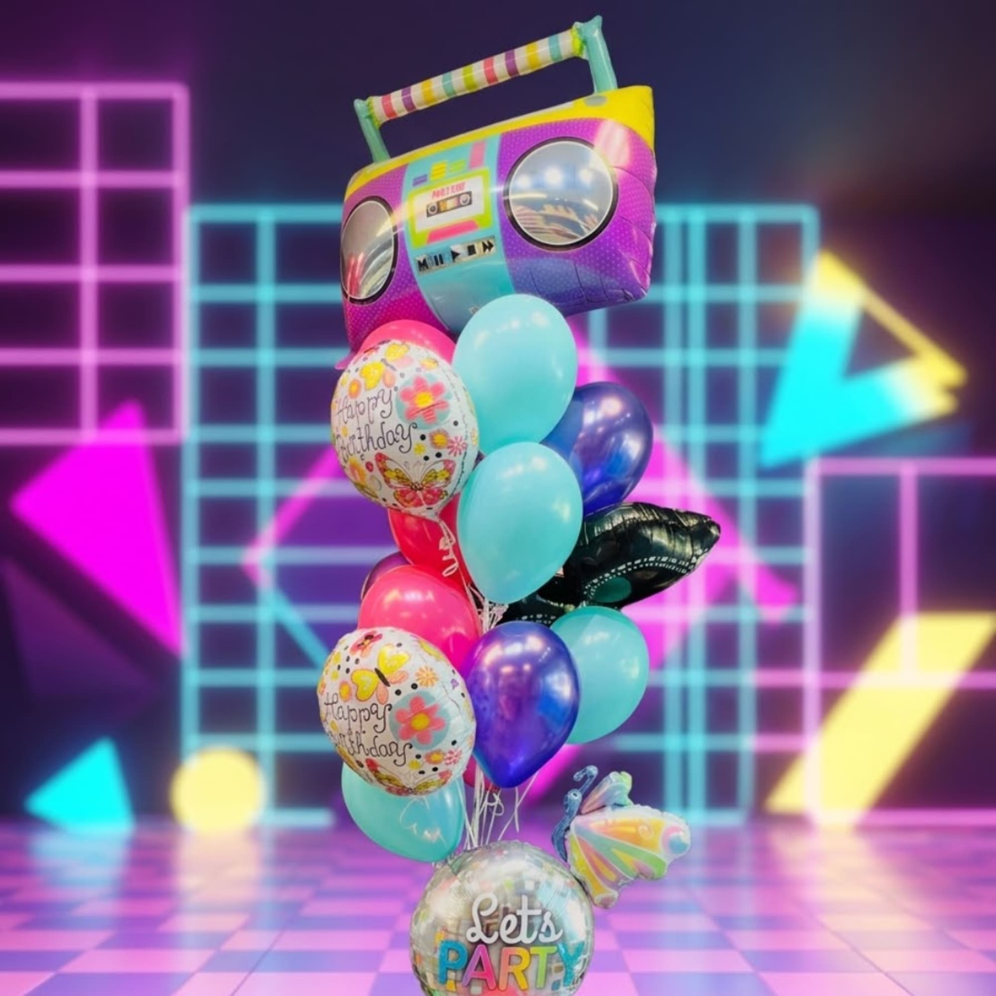 Colorful balloon bouquet with a large boombox-shaped balloon and birthday balloons
