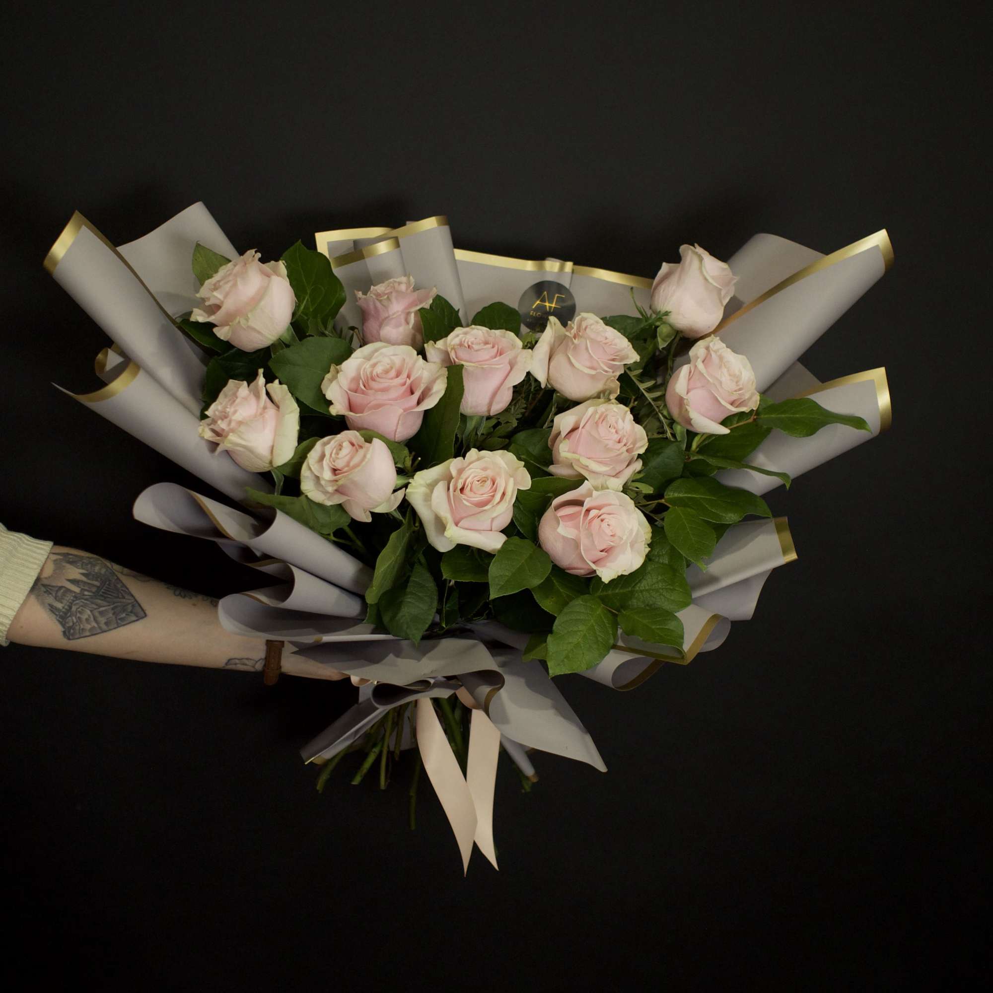 A contemporary bouquet of stunning light pink roses, thoughtfully designed with a