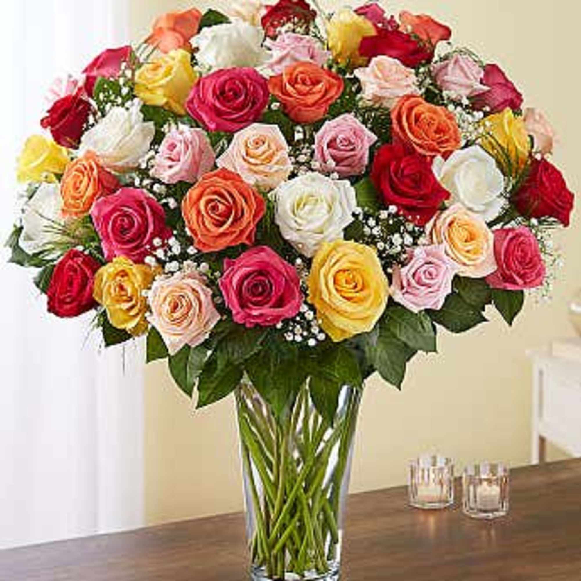 Mixed roses in a clear glass vase