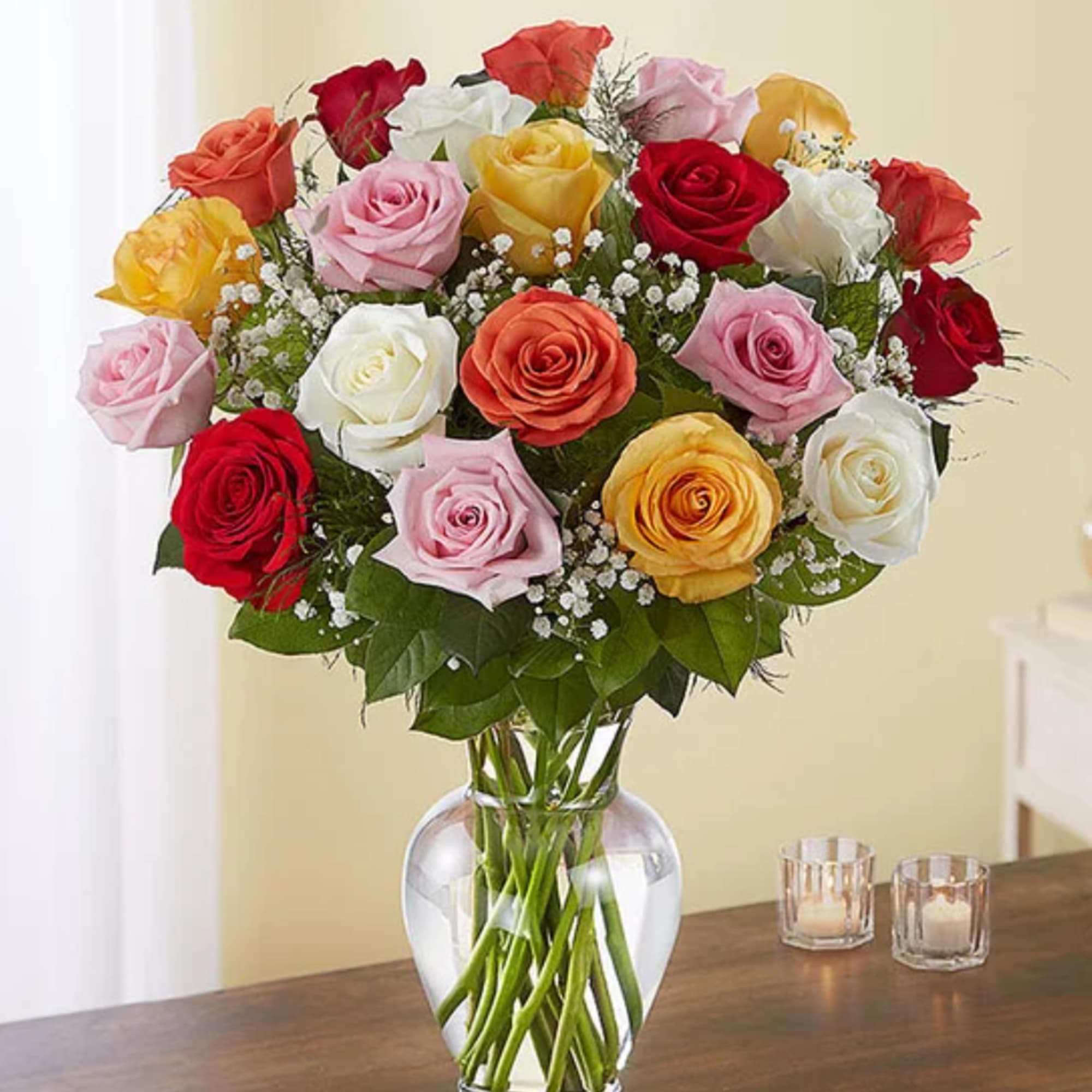 Mixed roses in a clear glass vase on a table