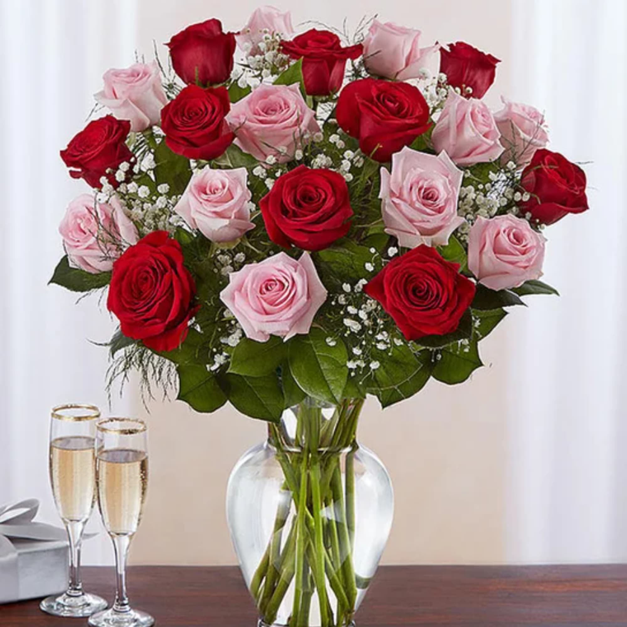 Bouquet of red and pink roses in a clear glass vase