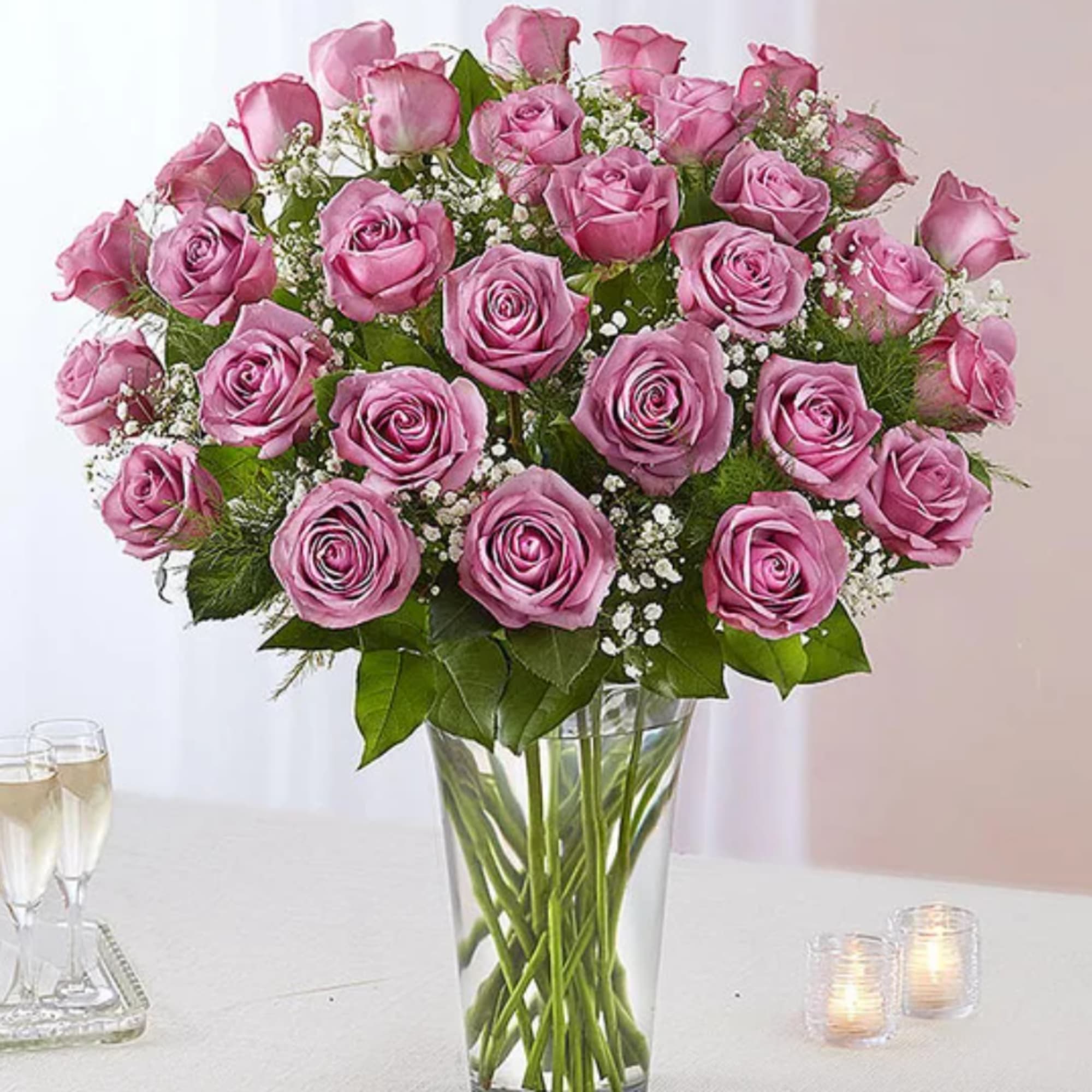 Pink rose bouquet in a clear glass vase on a table