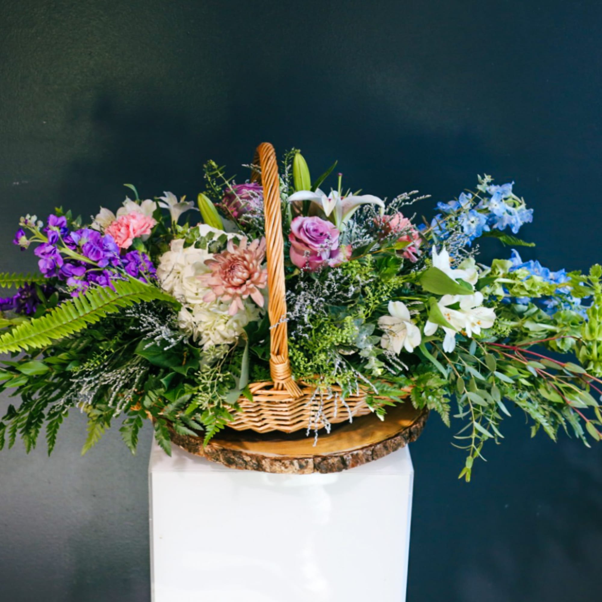 Mixed flower basket with purple, pink, white, and blue blooms
