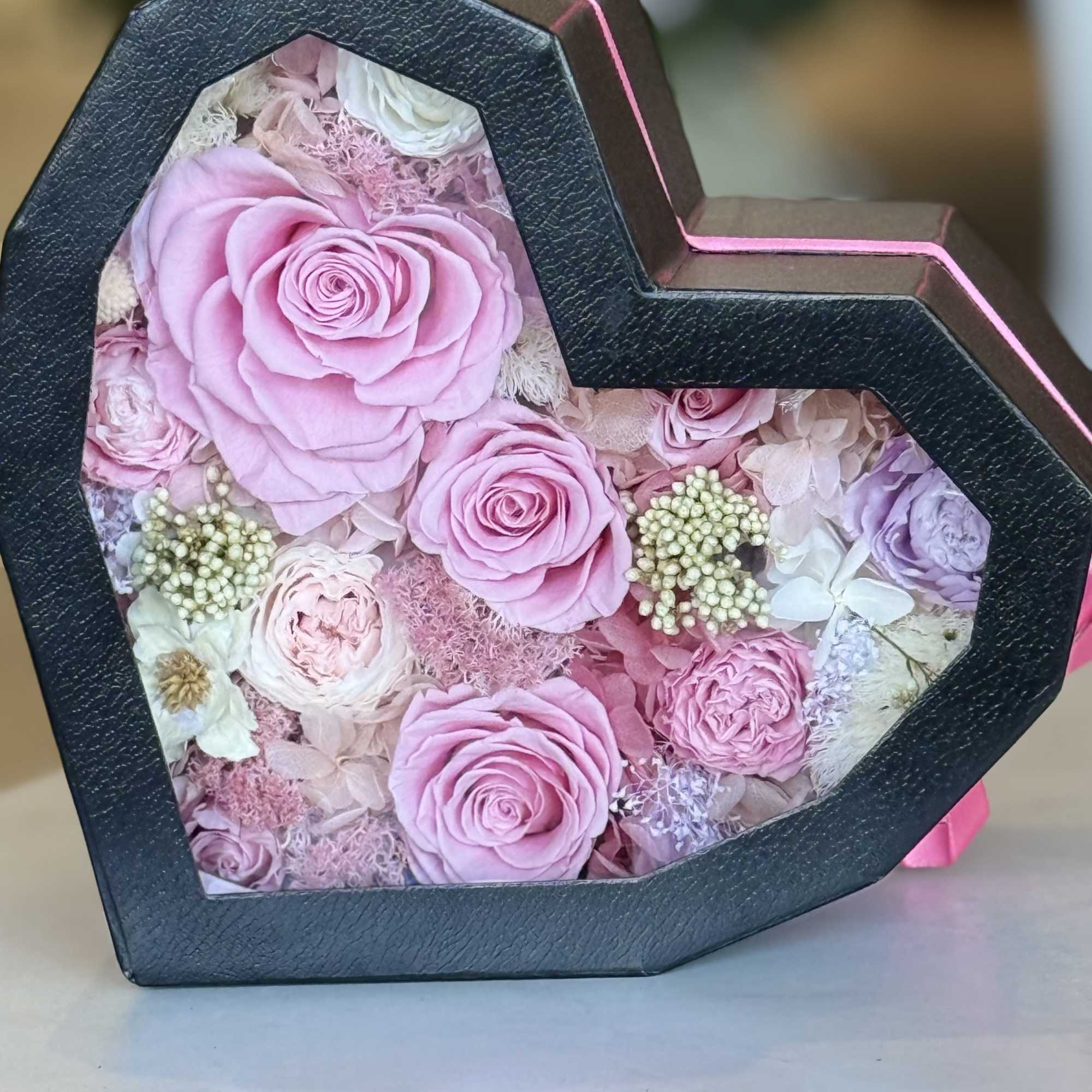 A heart-shaped black gift box reveals a keepsake of preserved roses and, photo 3 of 4