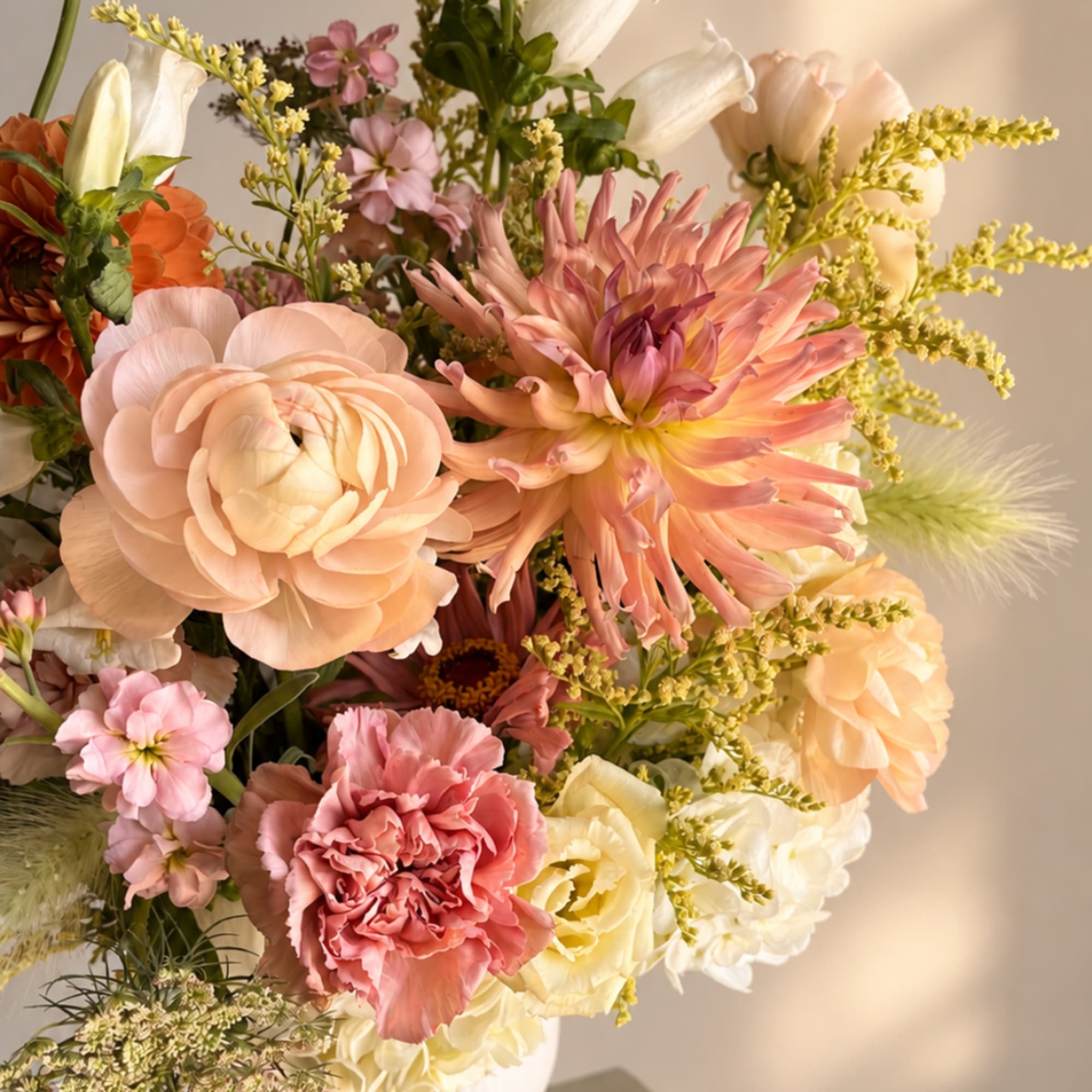 Pastel bouquet with peach, pink, and white blooms