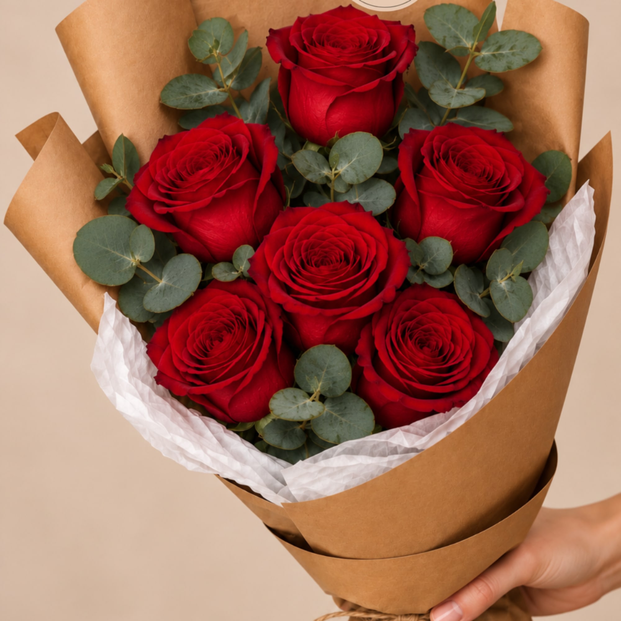 Bouquet of red roses wrapped in brown paper with white tissue, photo 2 of 3