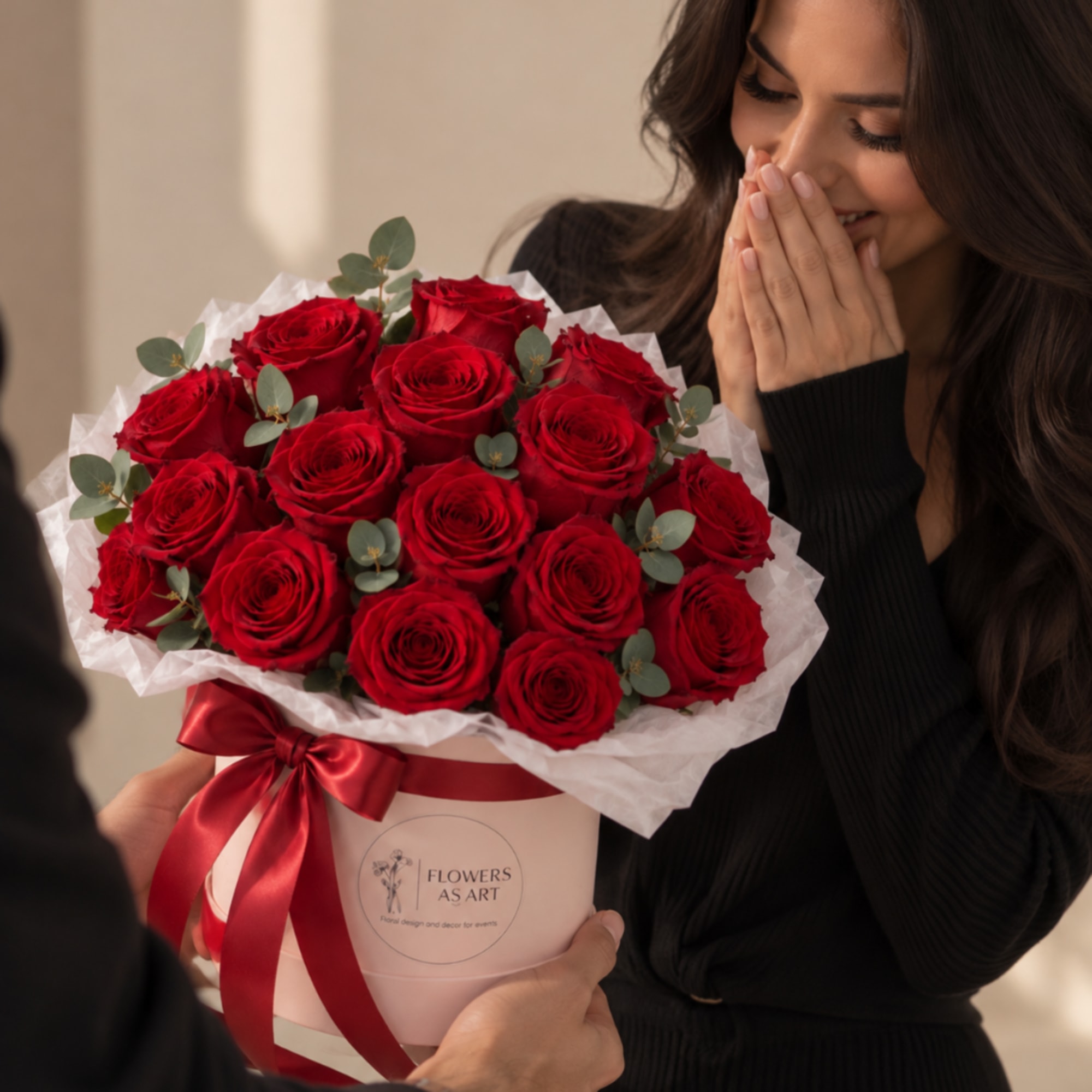 Bouquet of red roses in a pink box with a satin ribbon