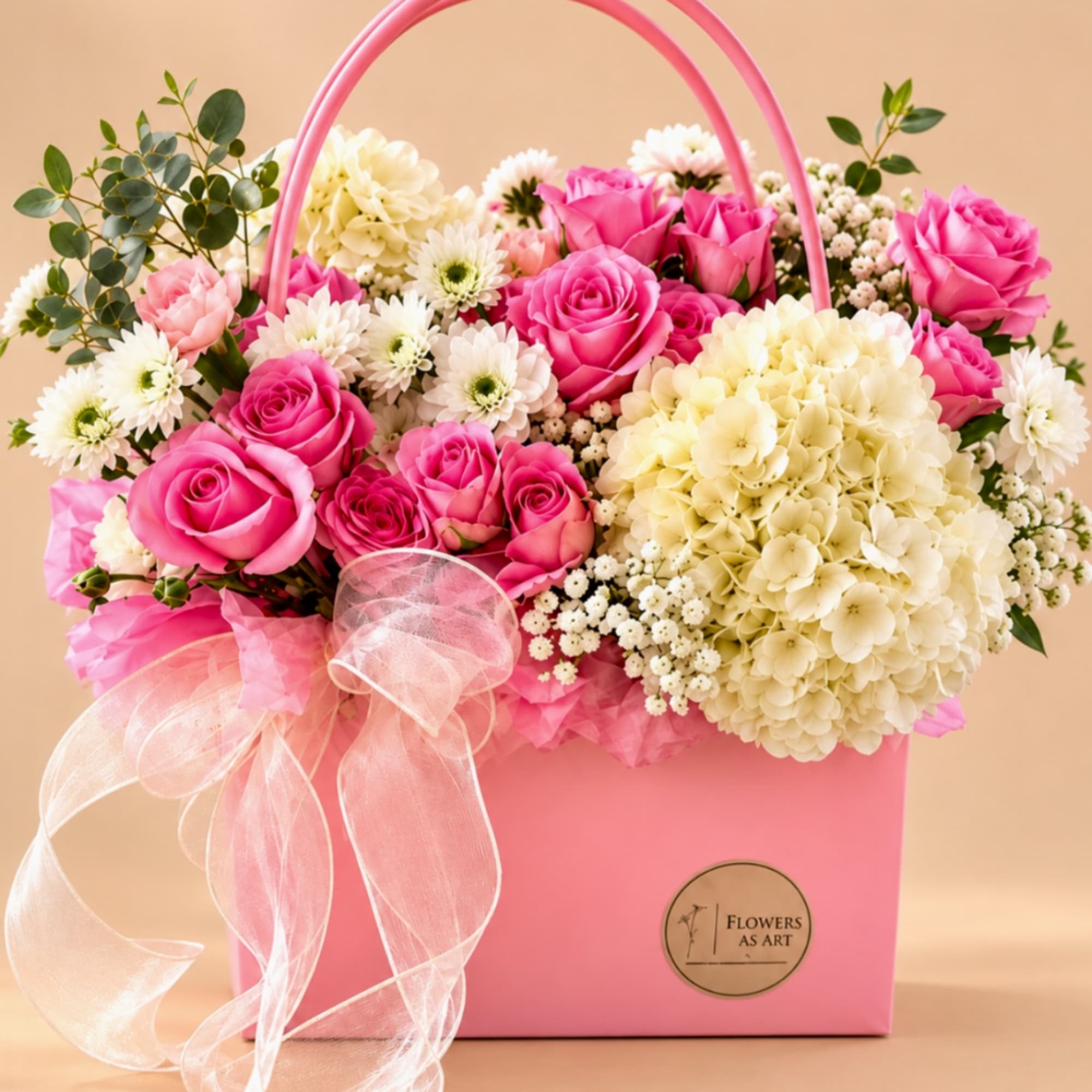 Pink roses and white flowers arranged in a pink gift box with a ribbon bow