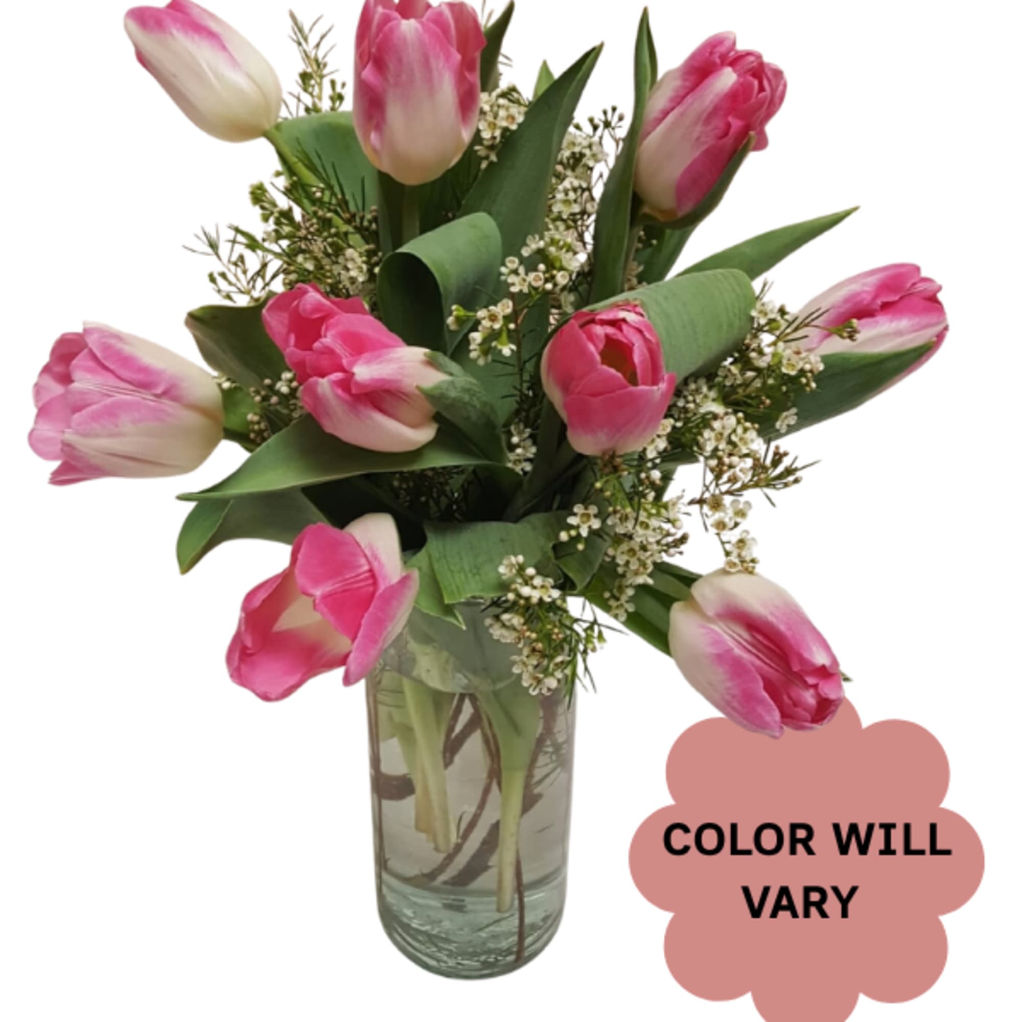 Pink tulips arranged in a clear glass vase with small white filler flowers