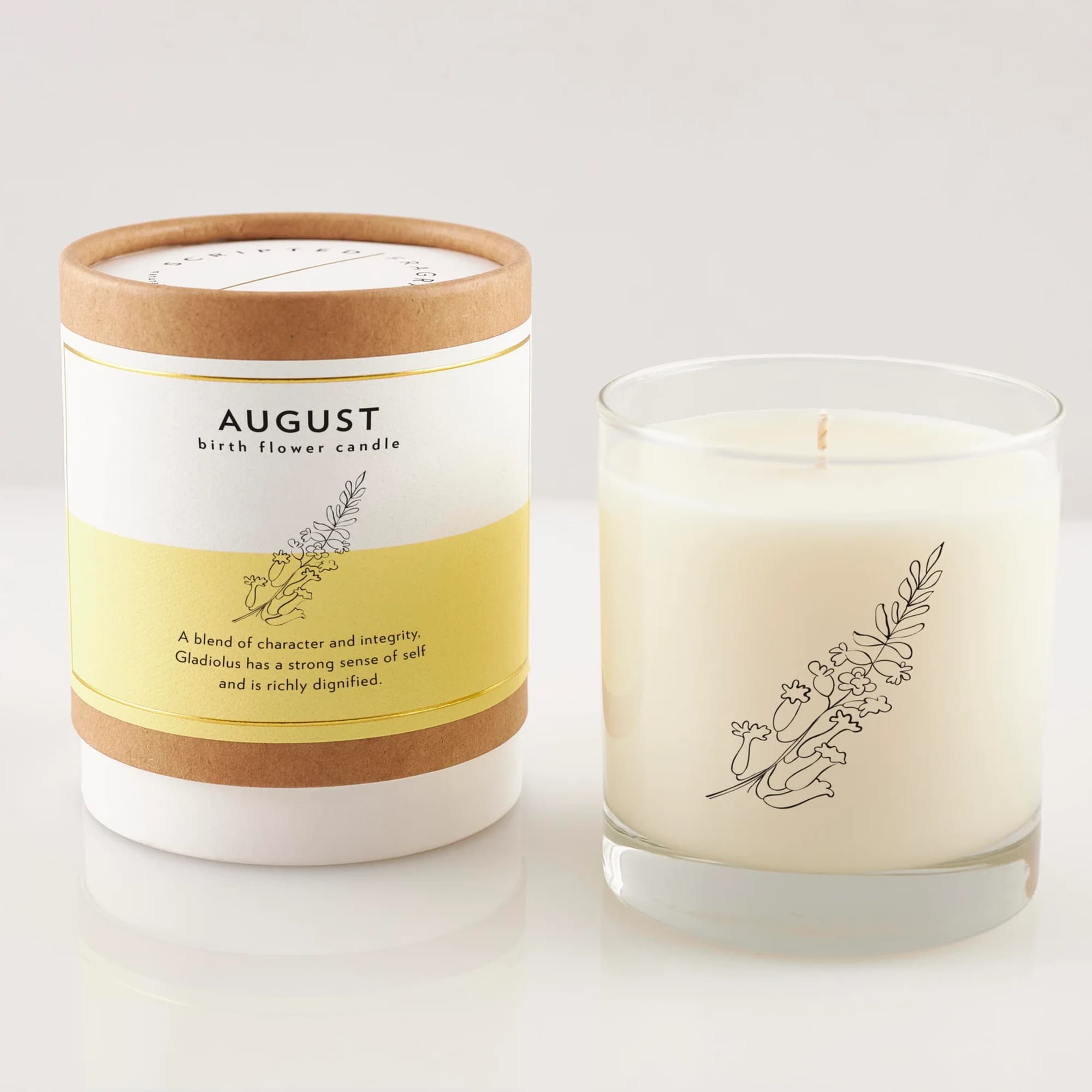 Two birth flower candles, one in a labeled box and one in a glass jar
