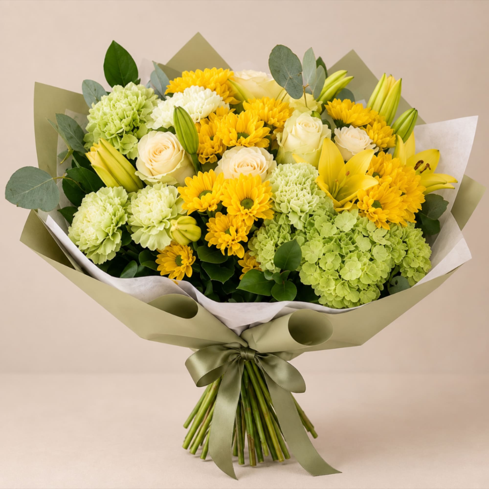 Bouquet of yellow and white flowers wrapped in green paper with a satin ribbon