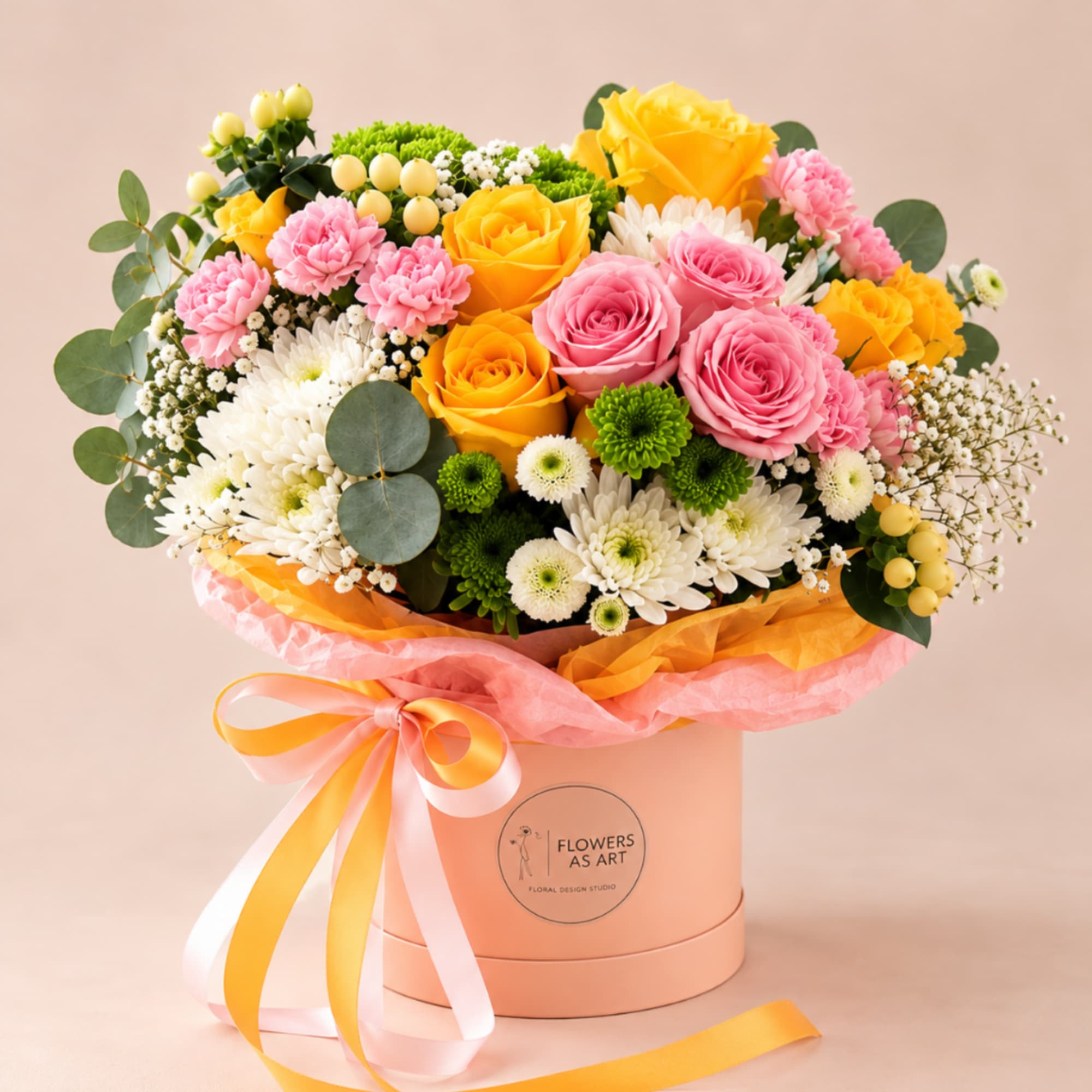 Bouquet of pink and yellow roses with white daisies in a round box