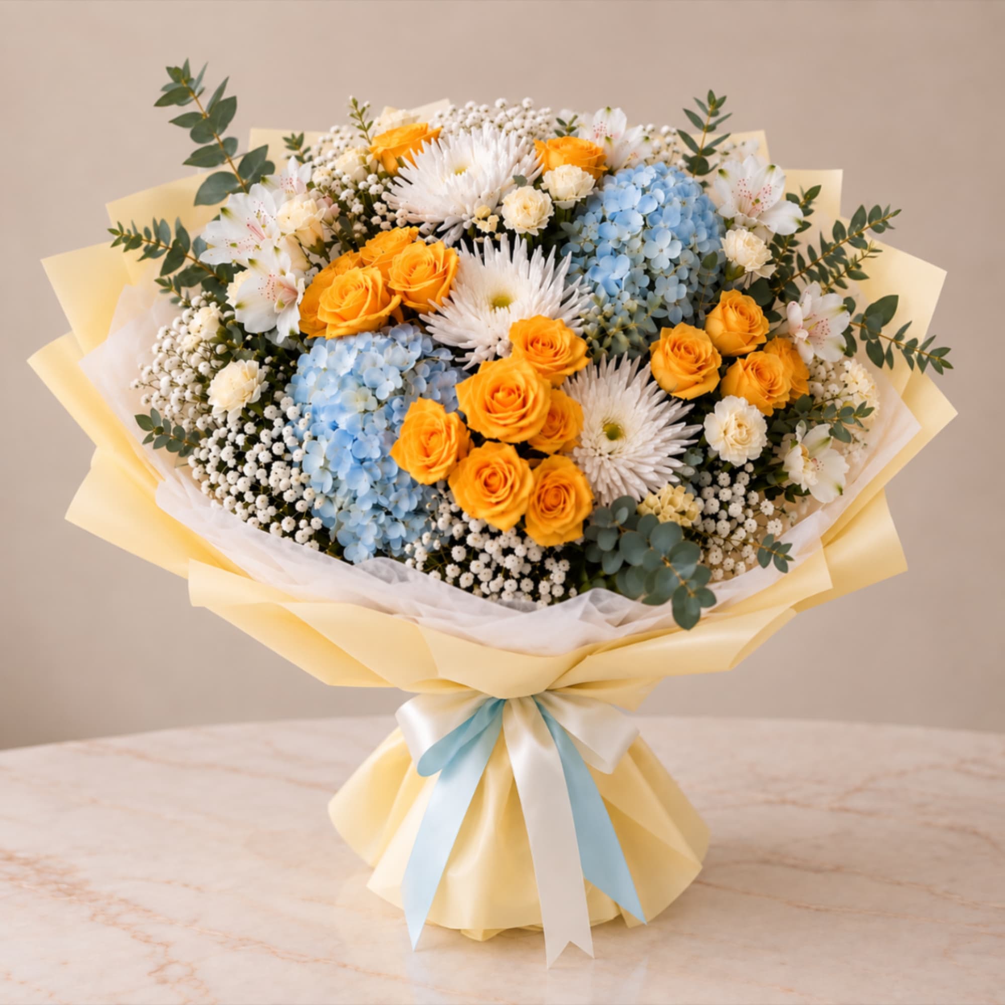 Bouquet of yellow roses, blue hydrangeas, and white daisies wrapped with ribbon