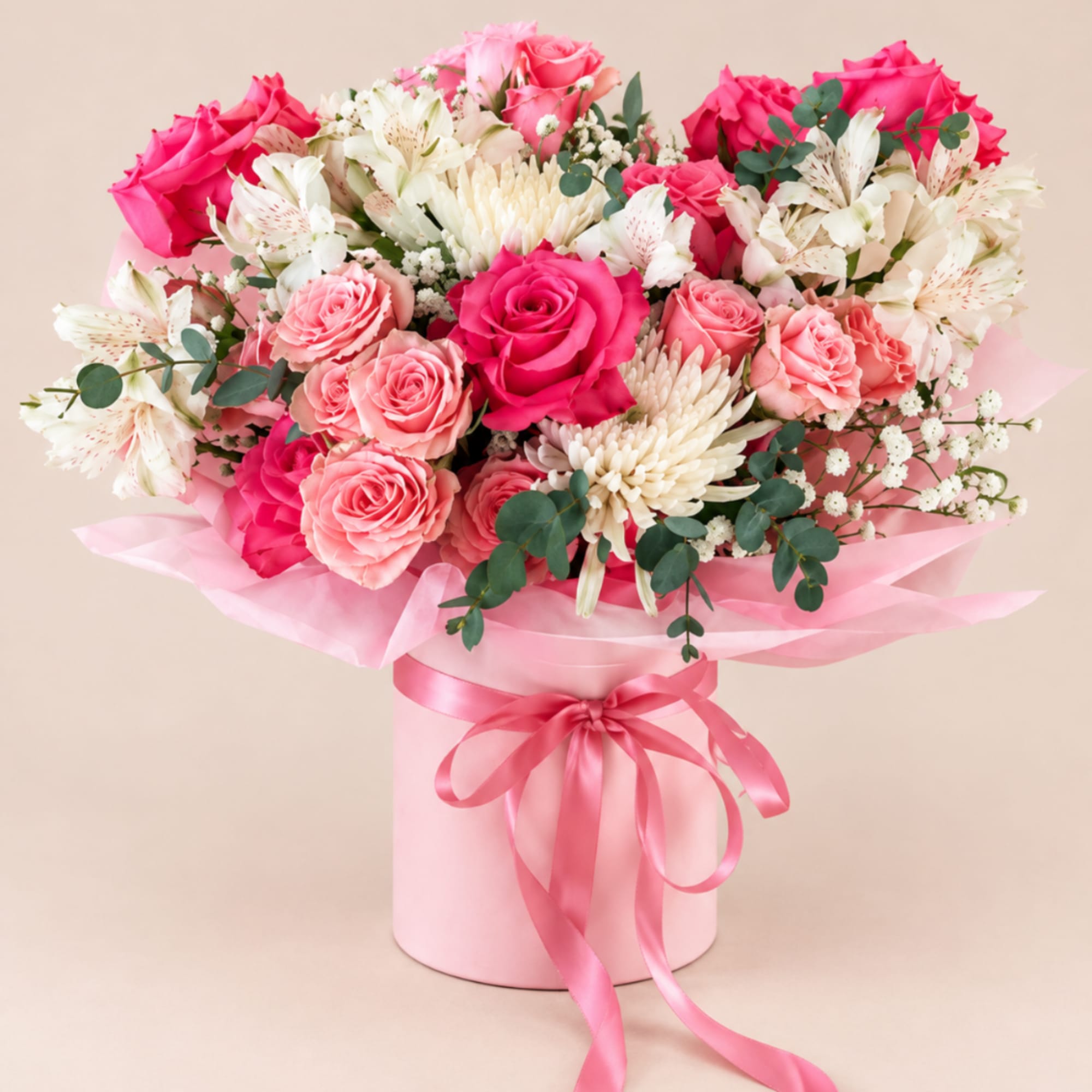 Pink and white rose bouquet in a pink hatbox with ribbon