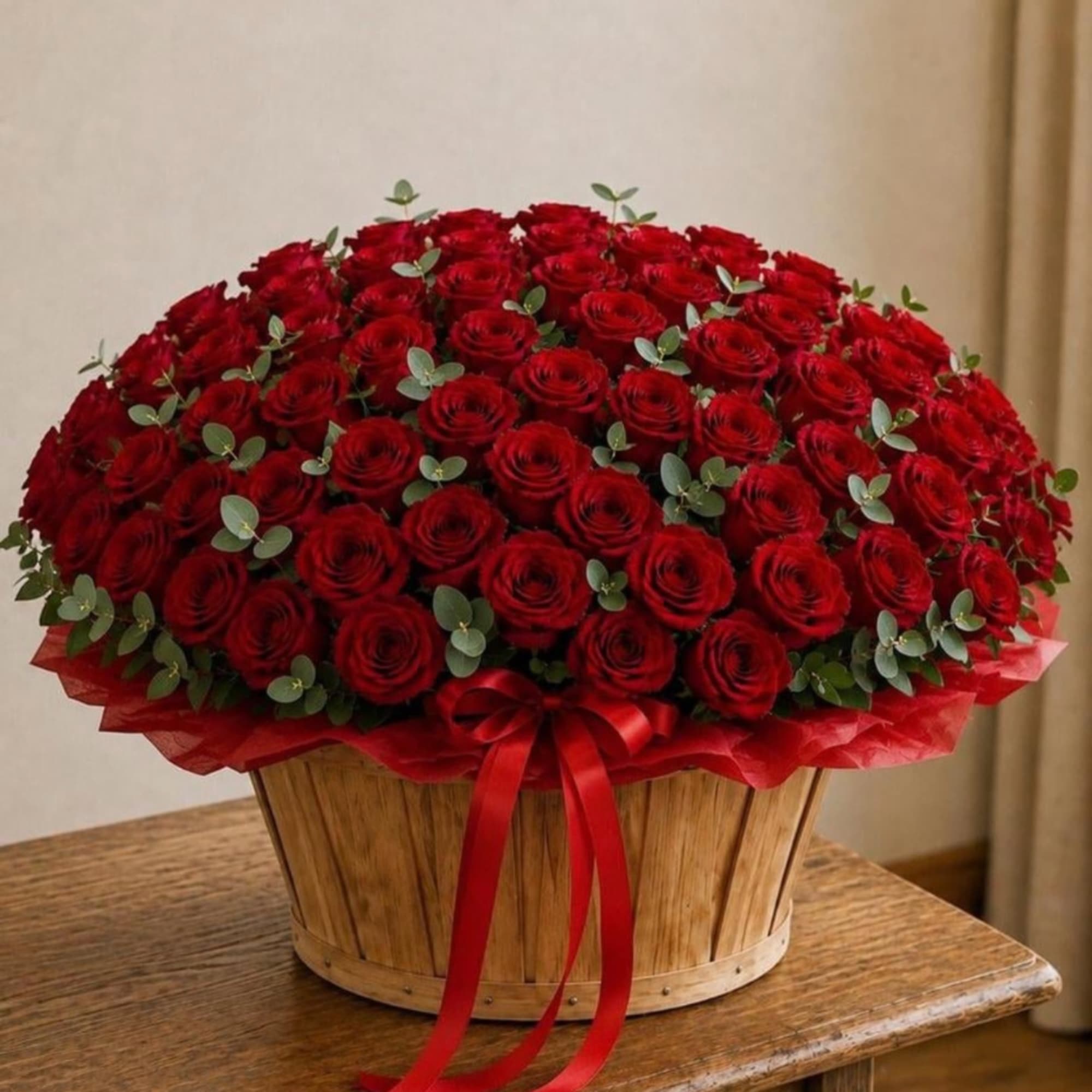 Large basket of red roses with a red ribbon