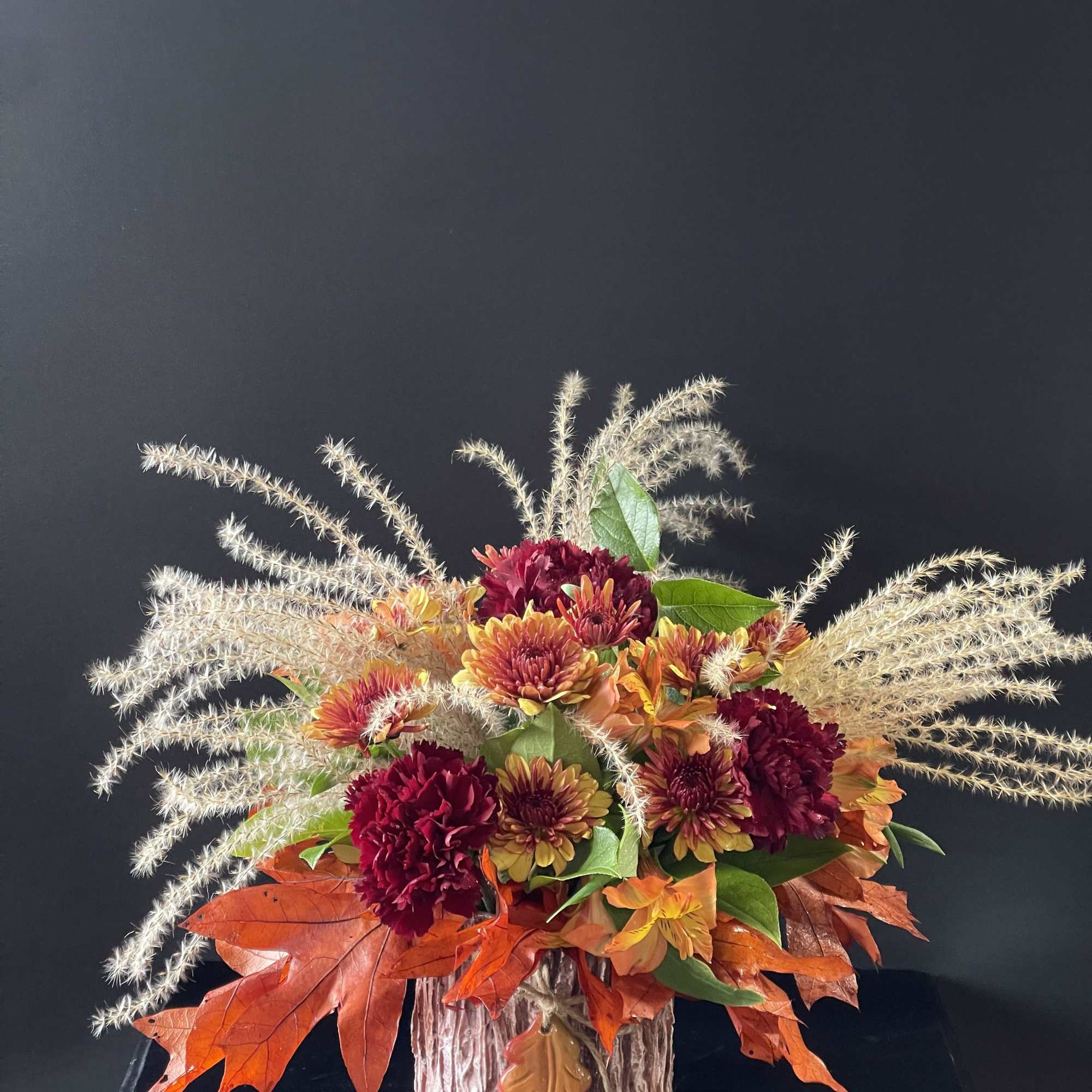 An arrangement that feels like a cozy fall day with fall leaves