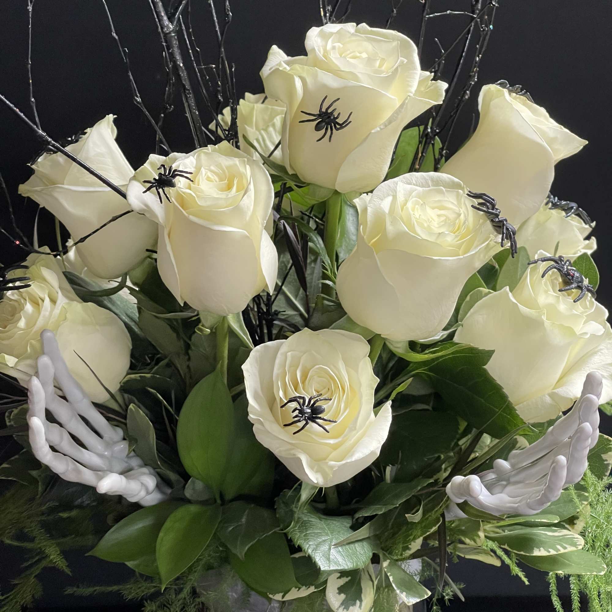 A dozen white Spooky Roses with spiders, spooky branches, and skeleton hands