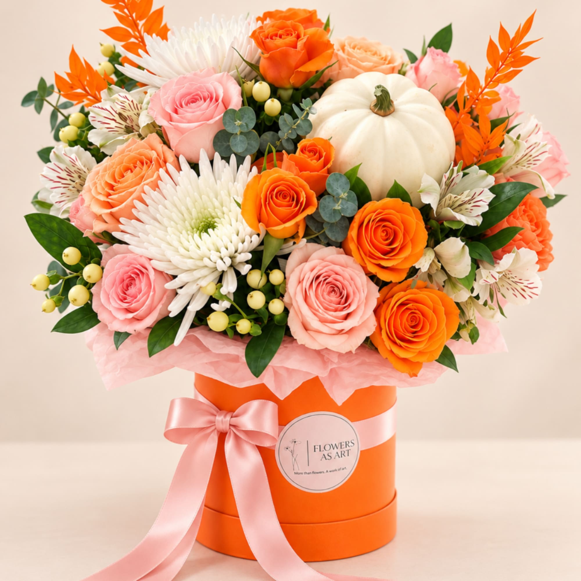 Bouquet of orange and pink roses with white blooms in an orange hatbox