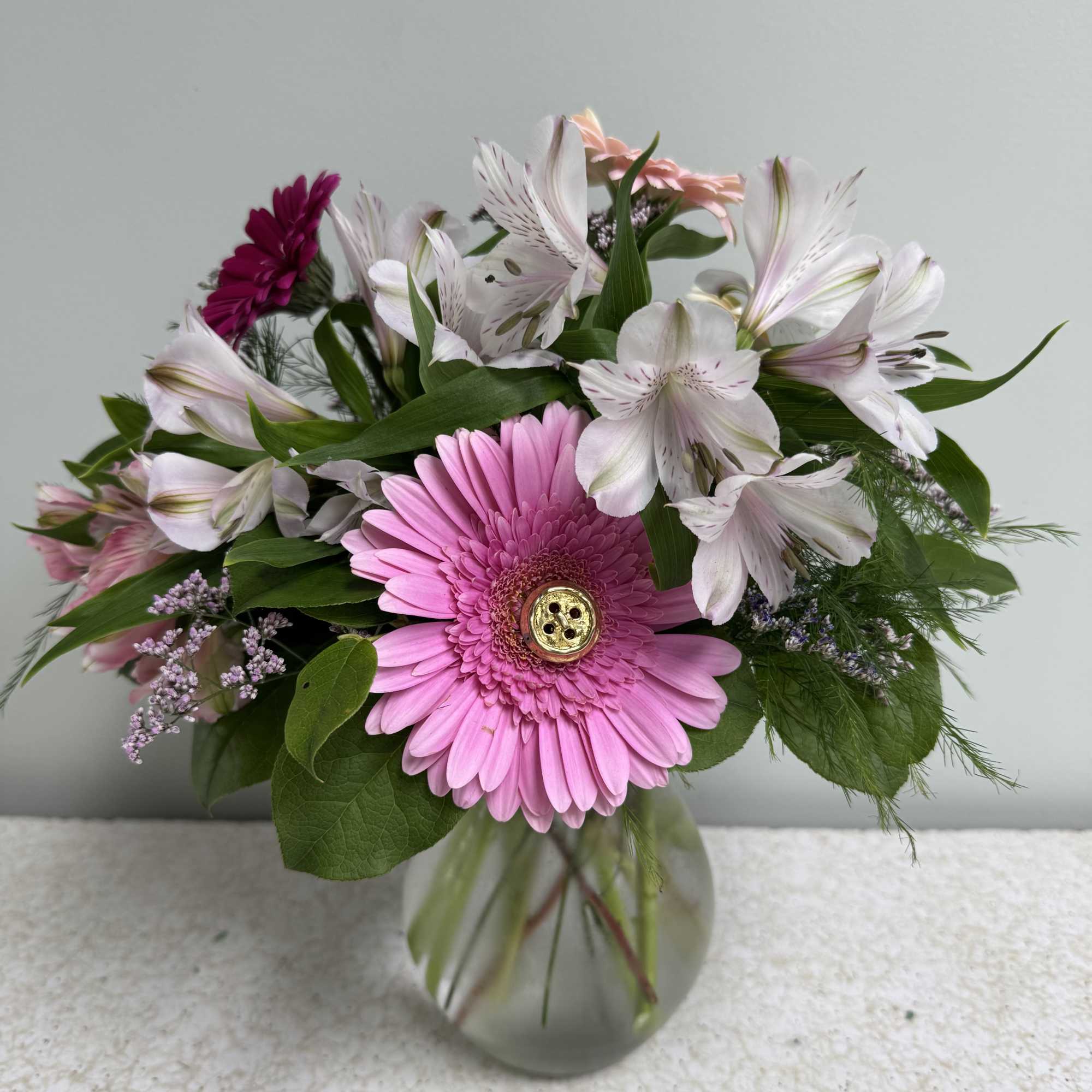 This little arrangement has 3 large gerbera daisies and 2 mini gerbera