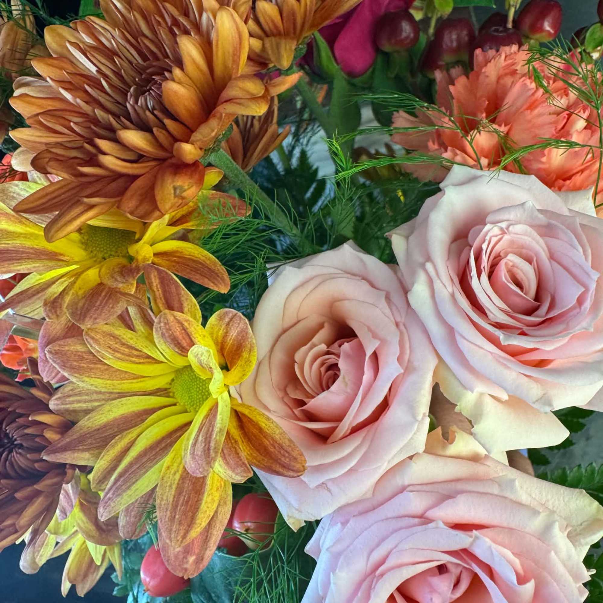 Pink roses and bronze chrysanthemums in a mixed bouquet