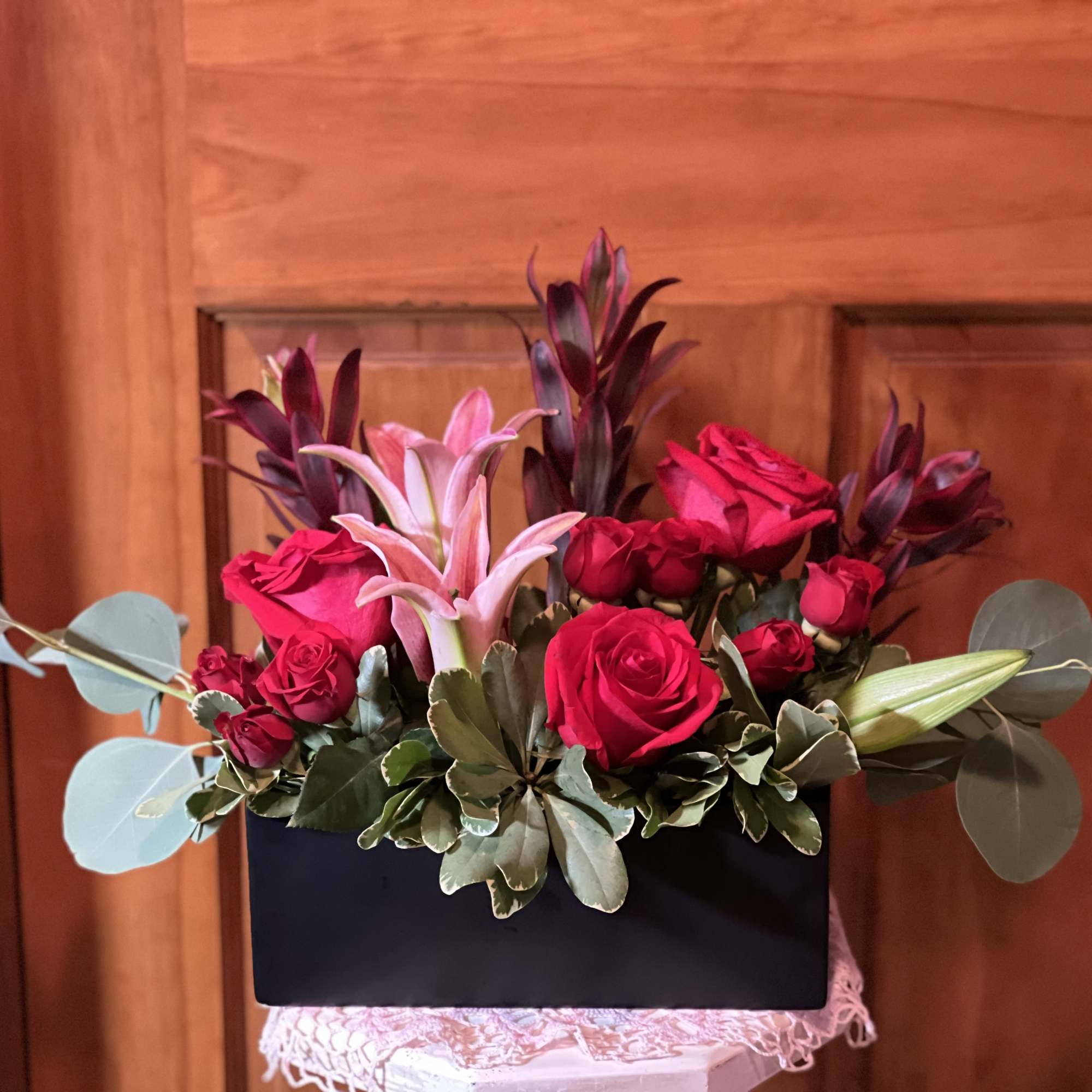 A stunning arrangement of lilies and colorful roses, mixed with an assortment