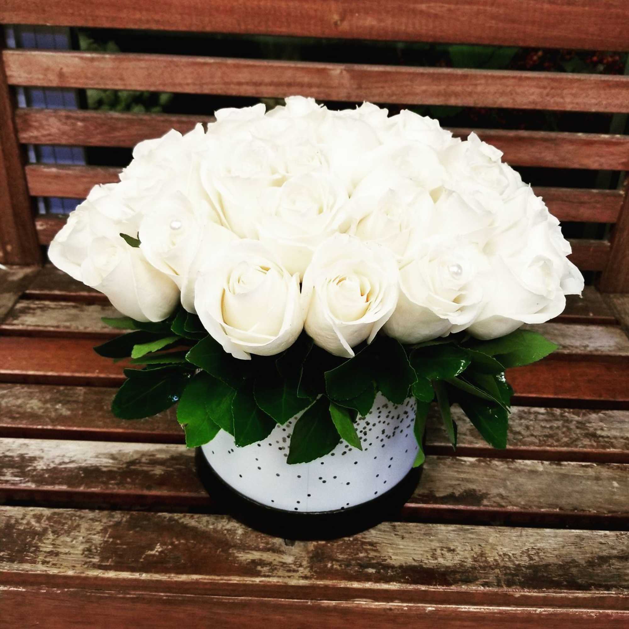 White rose bouquet in a spotted round box