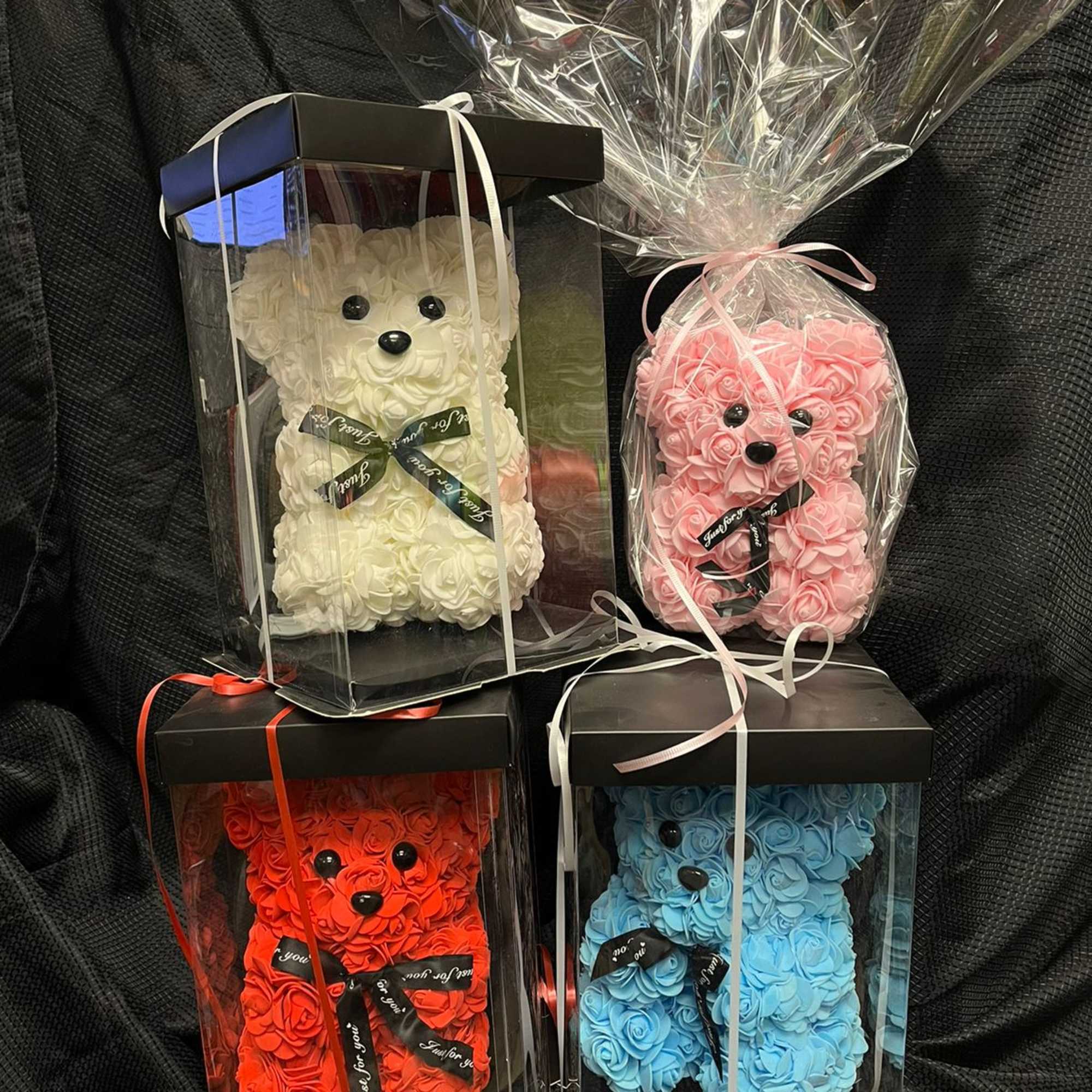 Four teddy bears made of roses in gift boxes
