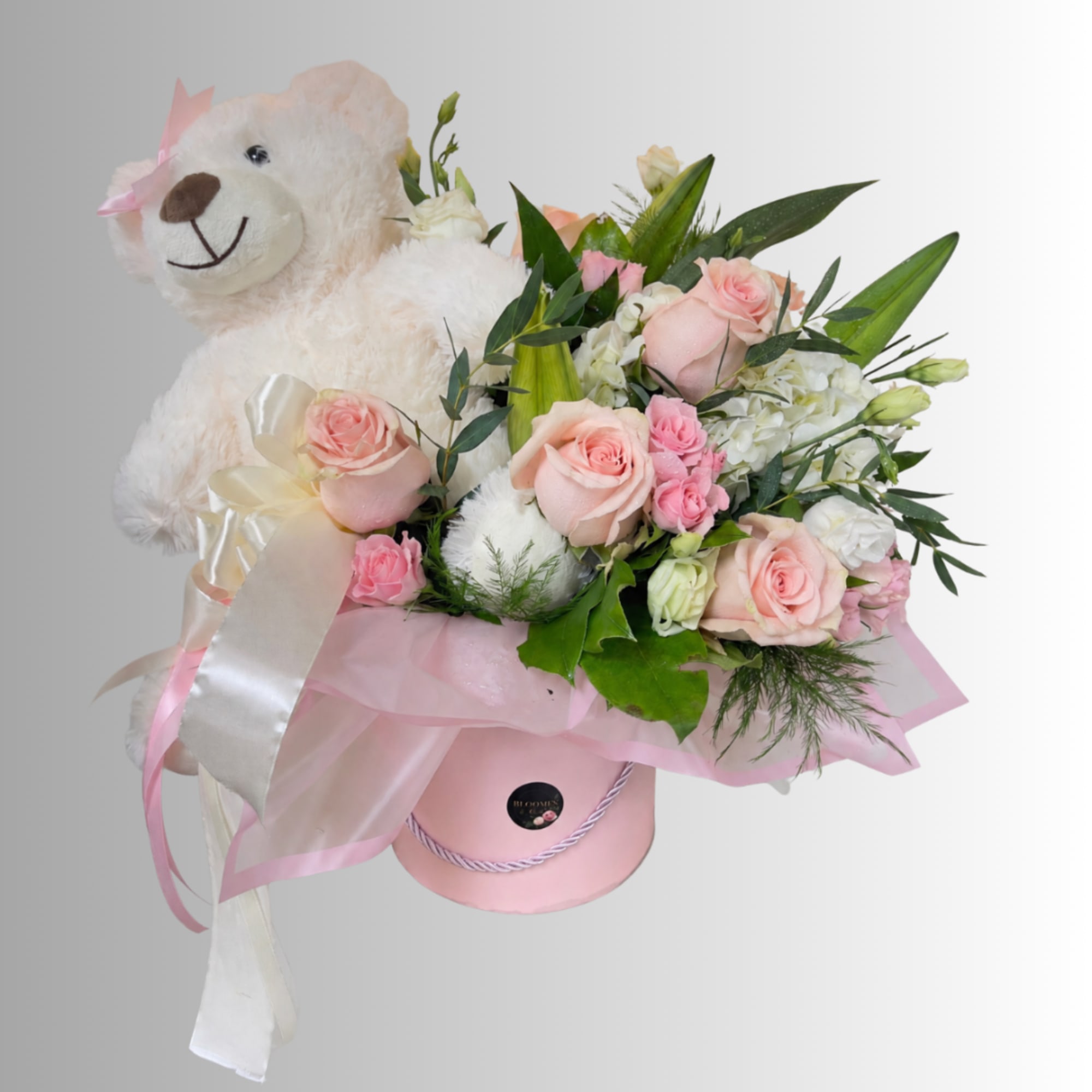 Pink rose bouquet with a teddy bear in a pink hat and box