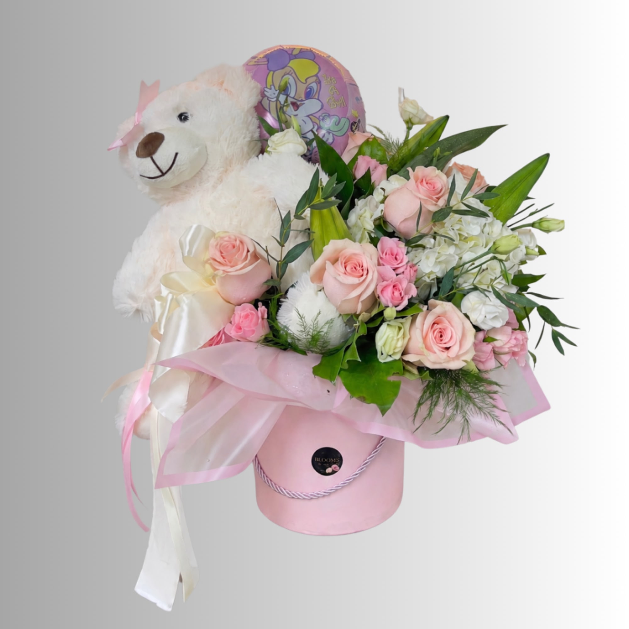 Pink rose arrangement with a teddy bear and balloon in a pink hatbox