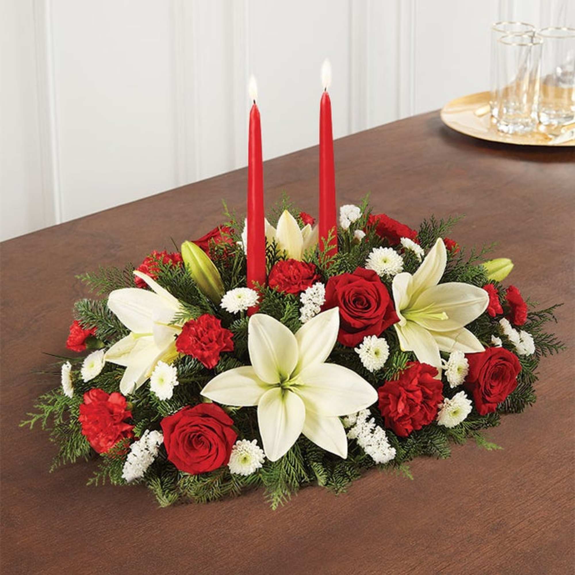 Red and white floral centerpiece with two red candles
