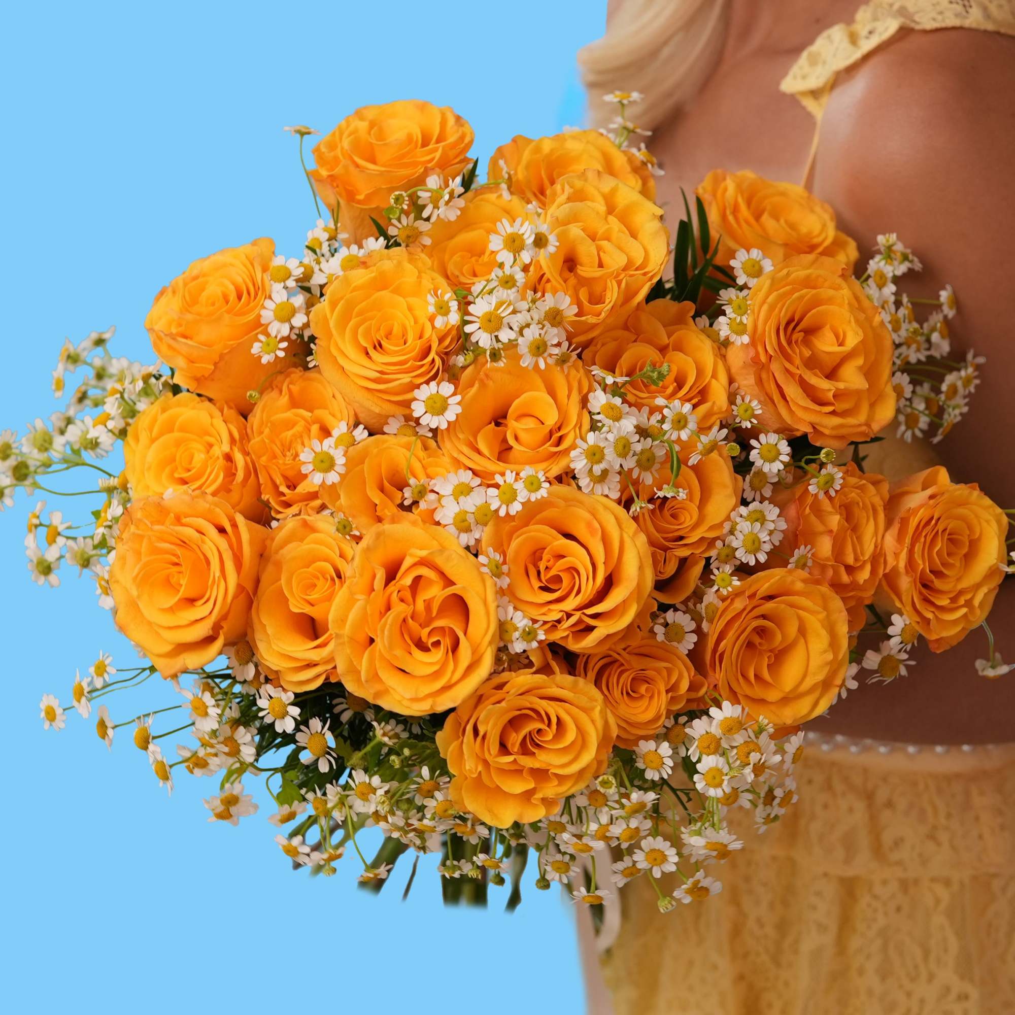 Woman holding a bouquet of orange roses and small white daisies